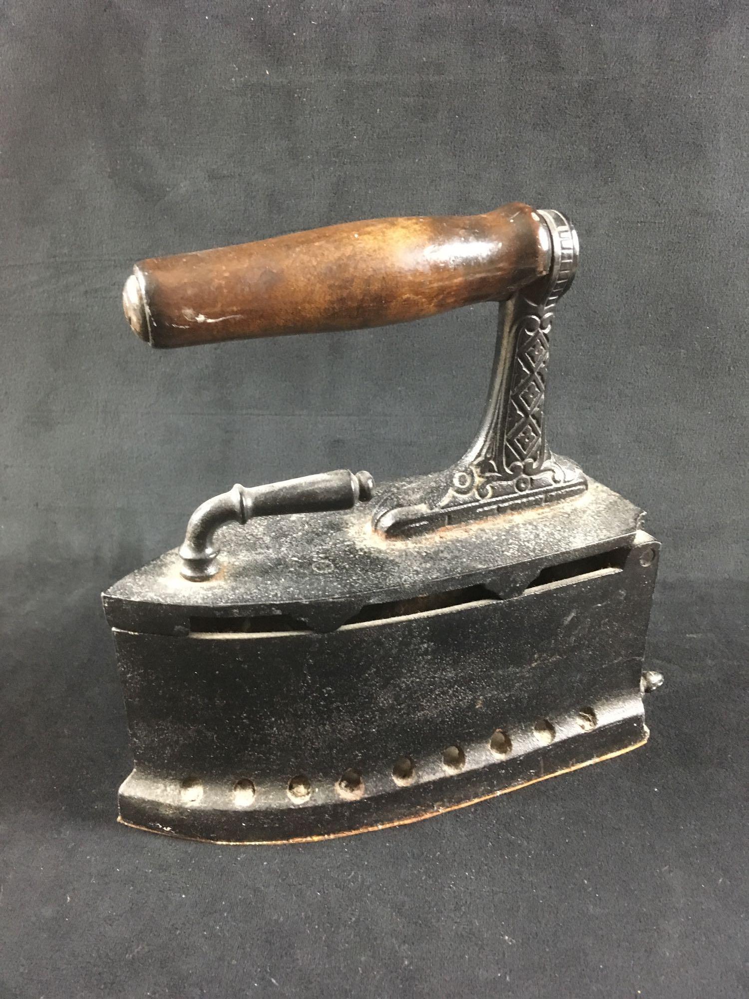 Cast Iron Charcoal Iron: Cast Iron Charcoal Iron. This iron is in fair condition. It has a bit of rusting on the top and needs to be cleaned out. The bottom of the iron has a piece of leather attached which is likely not orig