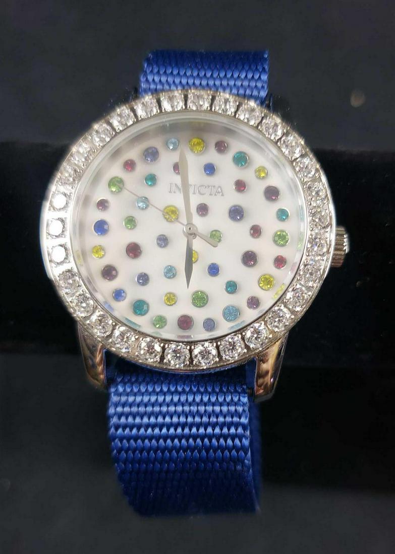 Invicta Angel Water Resistant Stainless Steel Watch: Invicta Angel Water Resistant Stainless Steel Watch. This watch is in great used condition. There is no known damage to the watch, however, it will need a new battery. The watch has blue nylon strap a