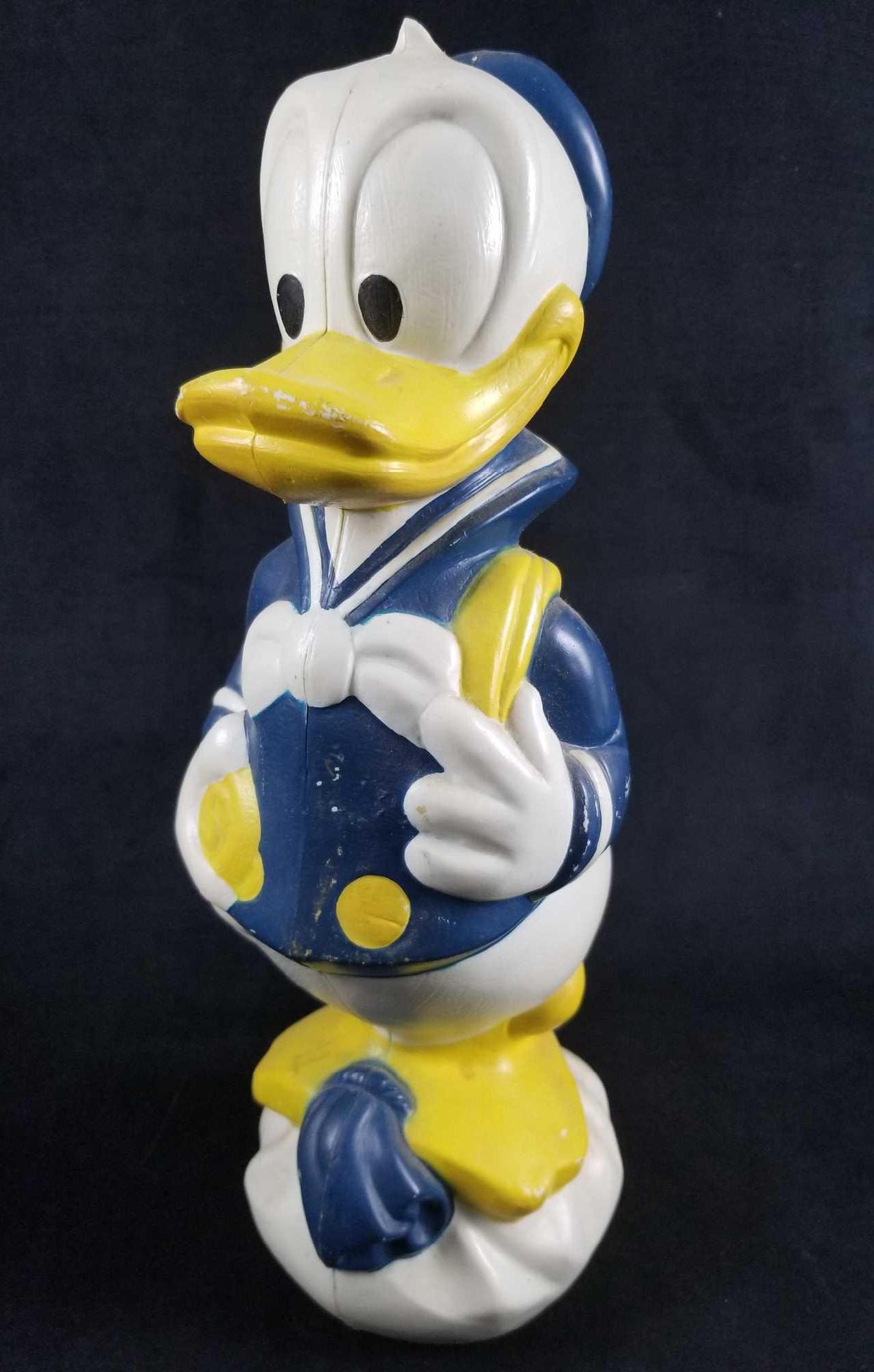 60s Donald Duck Blo Mold Bank. Transogram Disney Donald: This is an 18-inch tall Donald Duck blow molded plastic piggy bank manufactured by the defunct Transogram company, placing it as a pre-1969 or 1970 product. In good, vintage condition with only a cut
