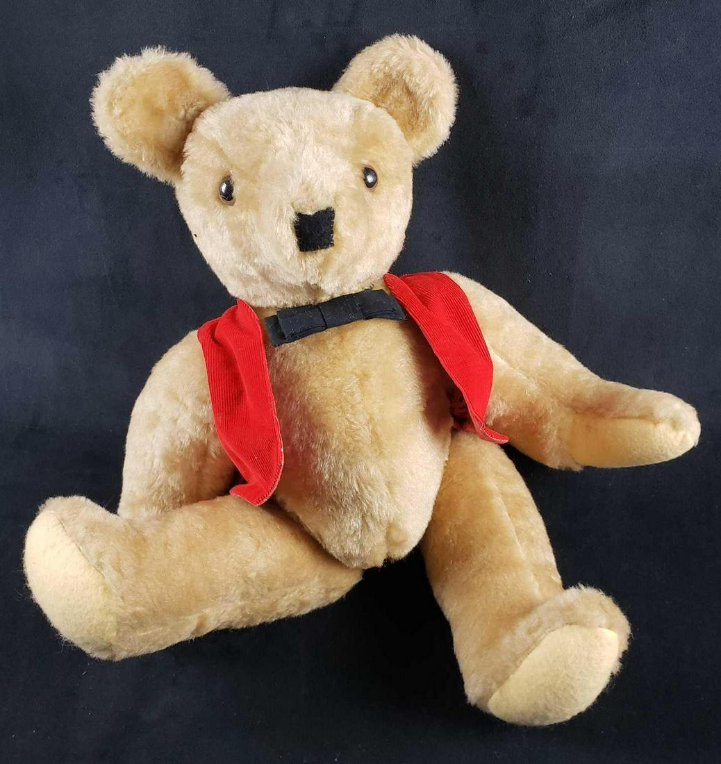 Teddy Bear with Bow Tie and Red Vest: Teddy Bear with Bow Tie and Red Vest. This teddy bear is in great used condition. The teddy bear has no known signs of damage to it. This teddy bear has moveable limbs and head. It includes removable