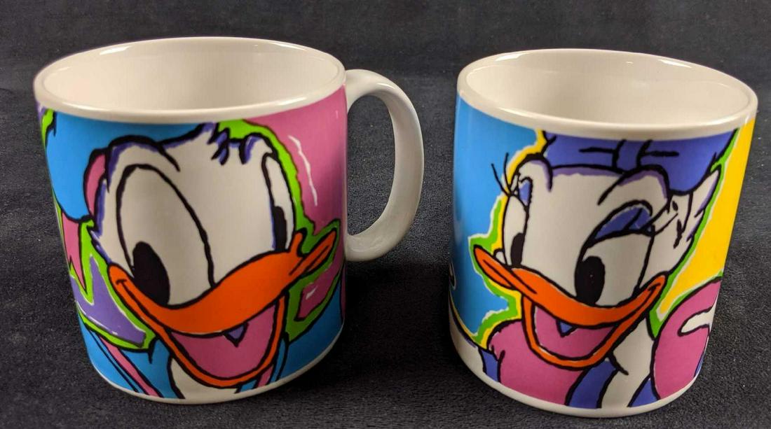 Disney His And Hers Donald And Daisy Duck Mugs: Ceramic Donald And Daisy Duck mugs. These colorful character mugs are approx approx 5" x 3" x 4" and are in good used condition with no noticeable scratches or chips. Made by the now defunctÂ Applau