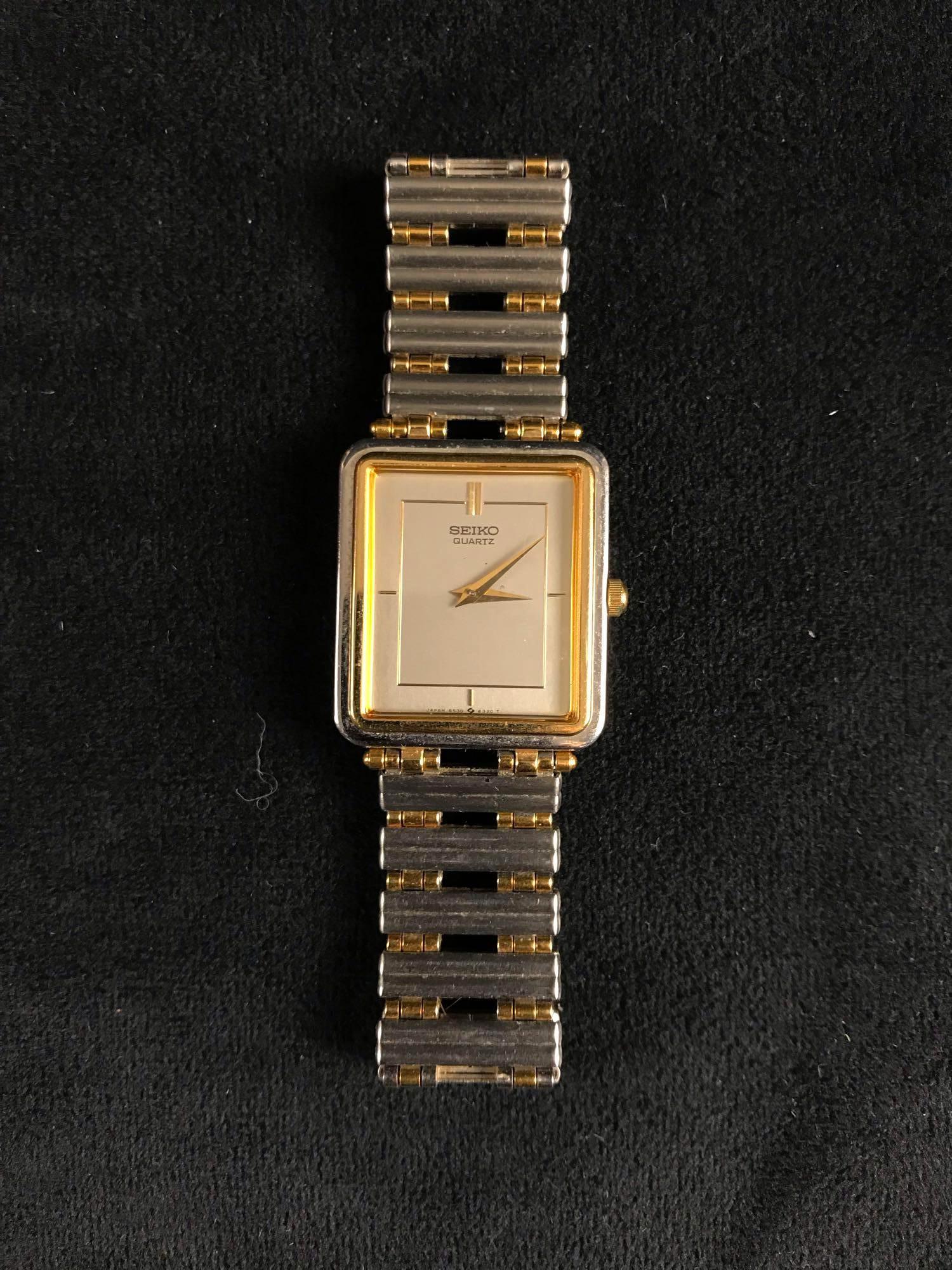 Seiko Quartz Silver and Gold Square Face Design: This Vintage Seiko Quartz with silver and gold design elements and a square face is in good used condition with no damages and very little minor scratches (does not show up on camera). Stainless steel