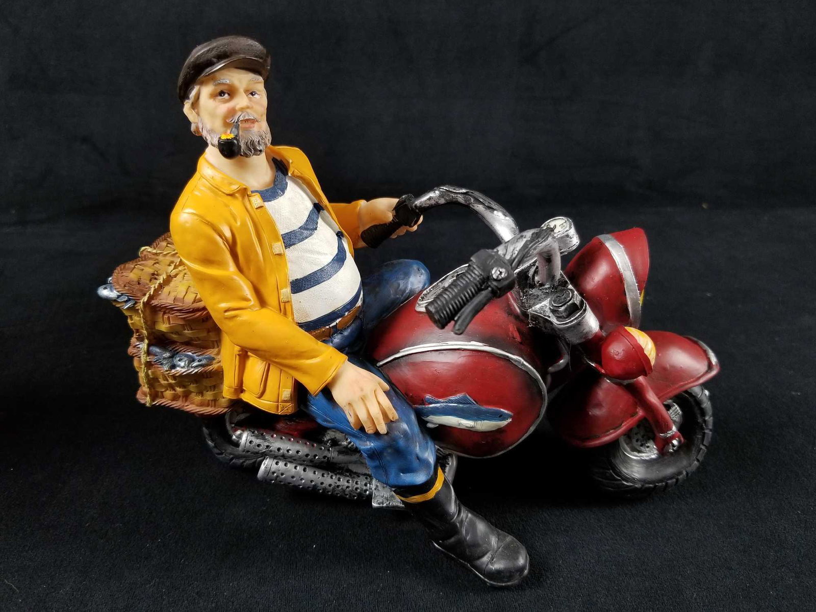 Motorcyle: Fisherman rides his "hog" into your heart. This very unique piece has a headlight feature that is untested. Is Approx 9" x 5" xÂ and made of durable poly-resin, this item is great for the nautical 