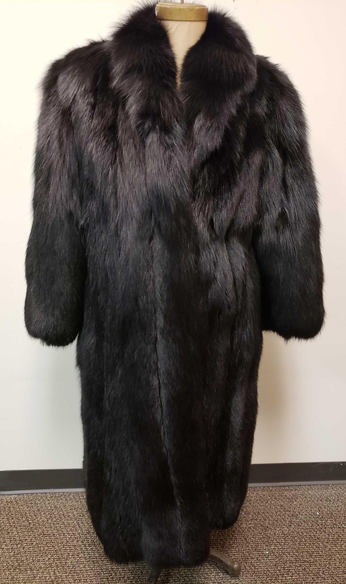 Les Fourrures Lord Inc Dyed Fox Fur Coat: Les Fourrures Lord Inc Dyed Fox Fur Coat. This fox fur coat is in fair used condition. The right sleeve has a large tear from around the cuff area to halfway up the sleeve. There is no other known dam
