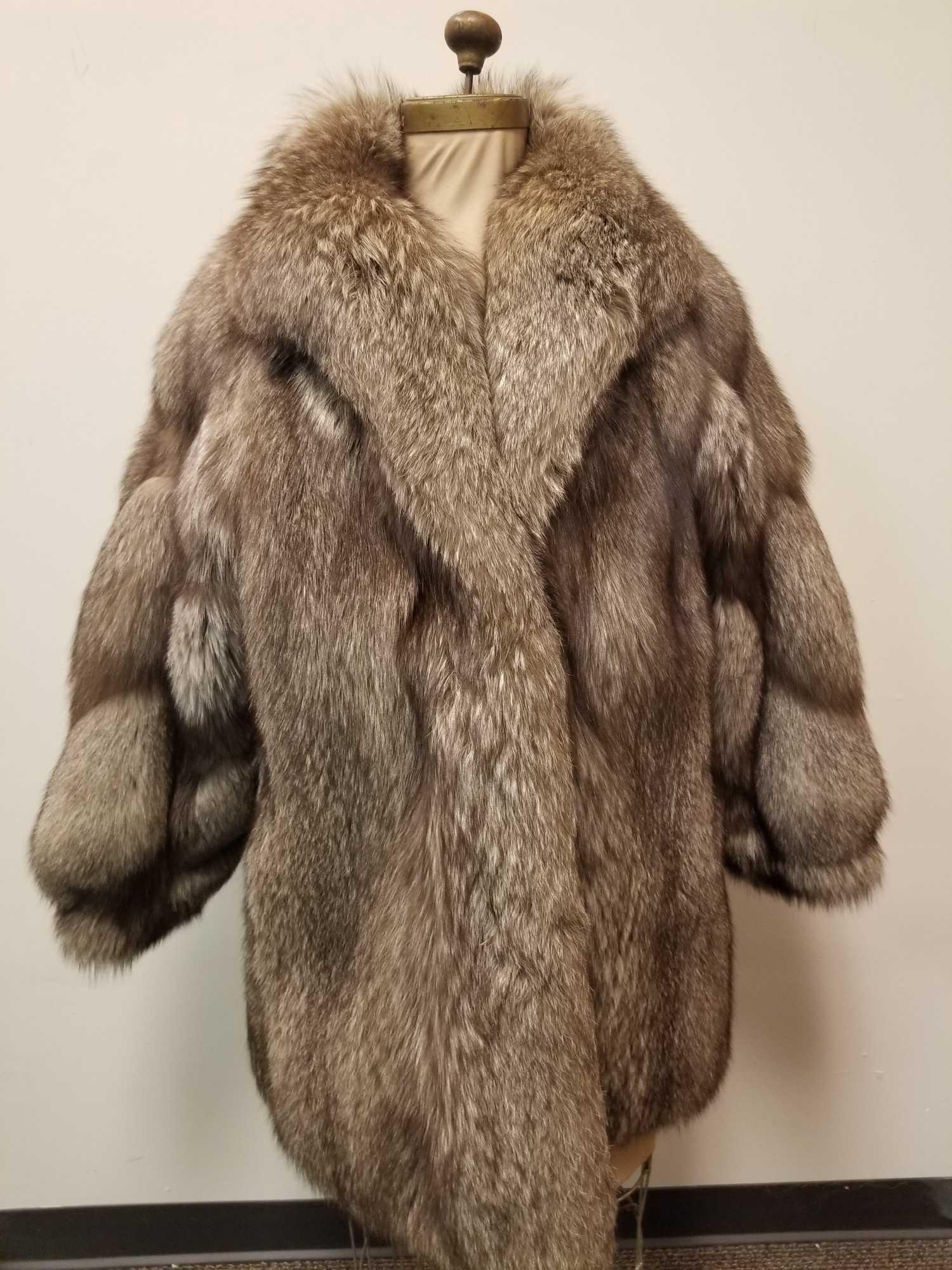 Soft and Rich Silver Fox Fur Coat: This soft and rich silver fox fur coat is by an unknown manufacturer. It is in good used condition however there is a tare in the fabric lining near the neck (see detail image). There are no other kno
