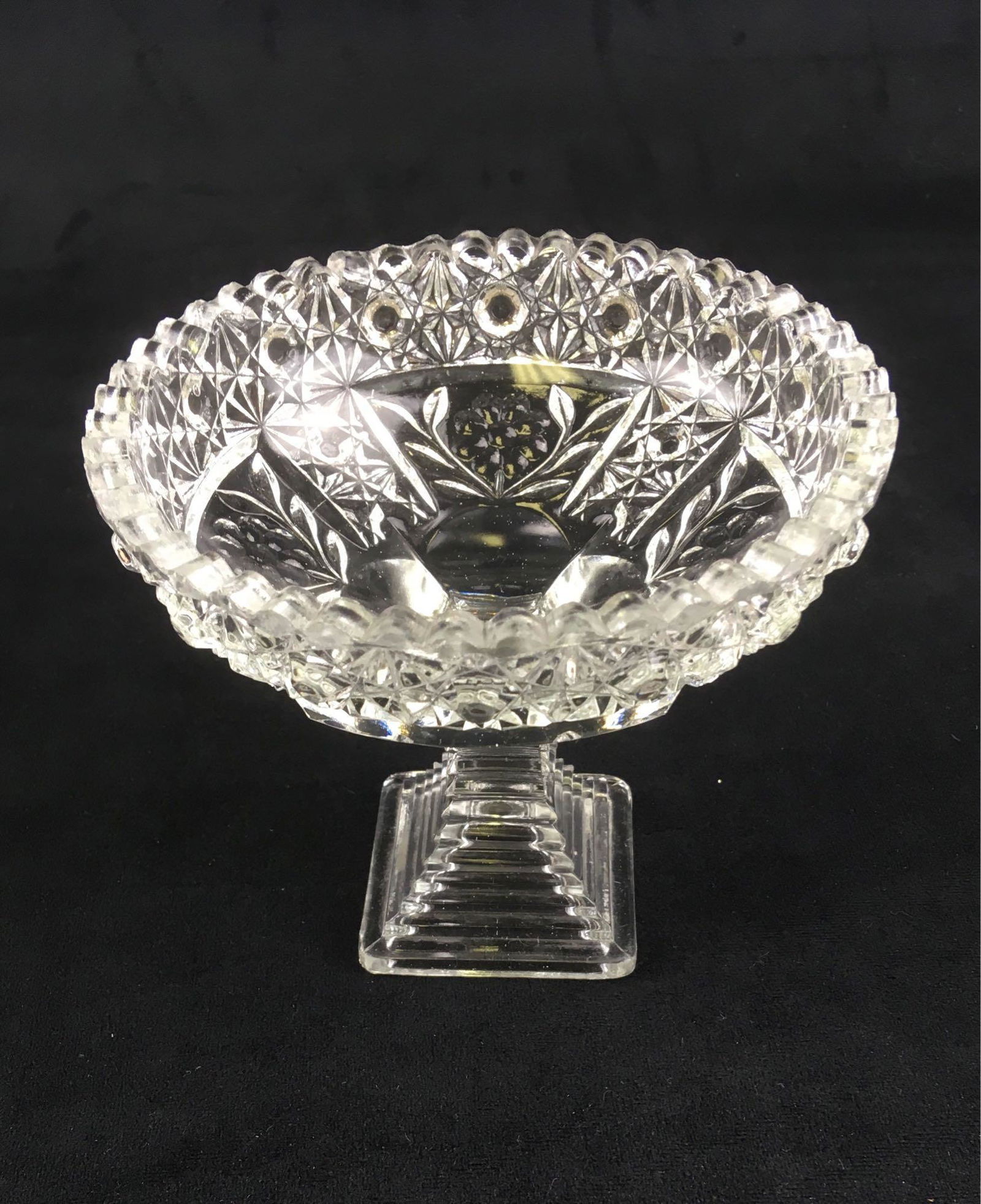 Vintage Glass Candy Dish: Crystal pedestal candy dish with daisy design. Measures 5" tall with a 2.1/2" square base, 5.1/2" in diameter.Â