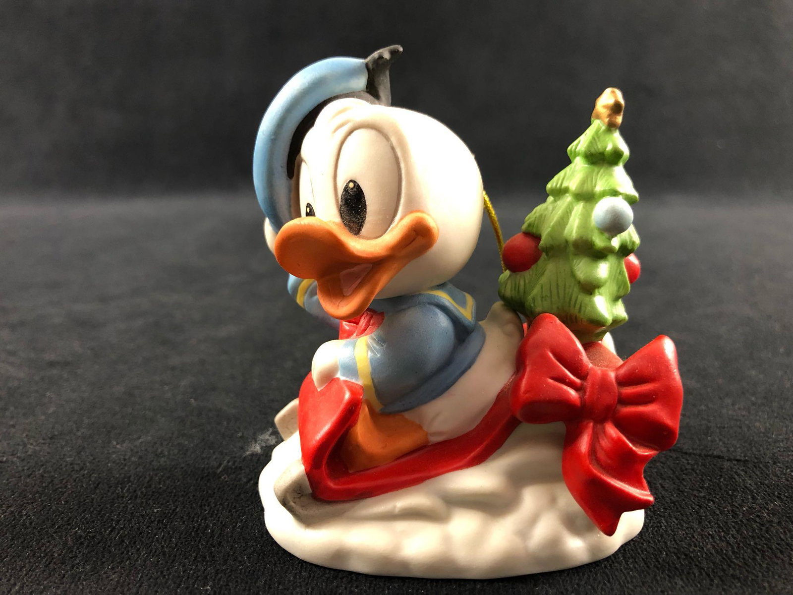 Vintage 1984 Donald Duck Baby Donald Delivering: Vintage 1984 Donald Duck Baby Donald Delivering Christmas Tree Ceramic Ornament You are viewing a Baby Donald Duck Christmas Ornament on a red sled with Tree . This is a bisque ornament, in great cond
