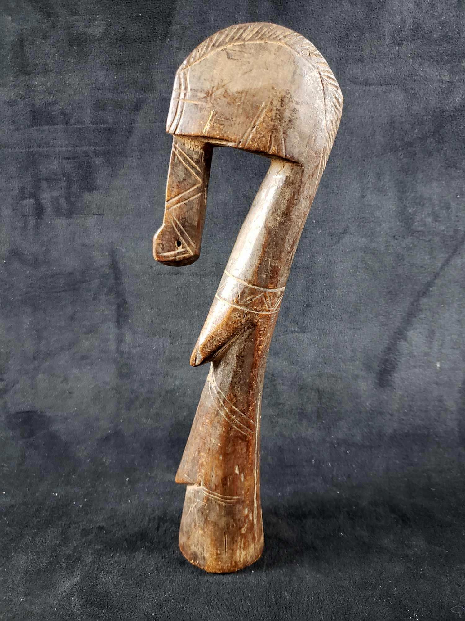 African Abstract Figure Sculpture: African Abstract Figure Sculpture. This sculpture is in good condition. The figure appears to have a piece missing on the front where there is a hole through the chin/beard. The figure is made out of 