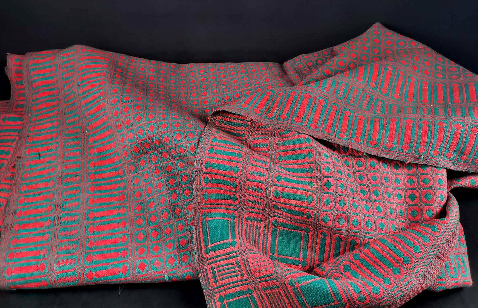 Large Woven Reversible Geometric Throw or Rug: This large woven reversible throw or rug depicts a green and neon pink geometric pattern. Possibly made in South America. This blanket is in good condition with some snags and markings (see detail ima