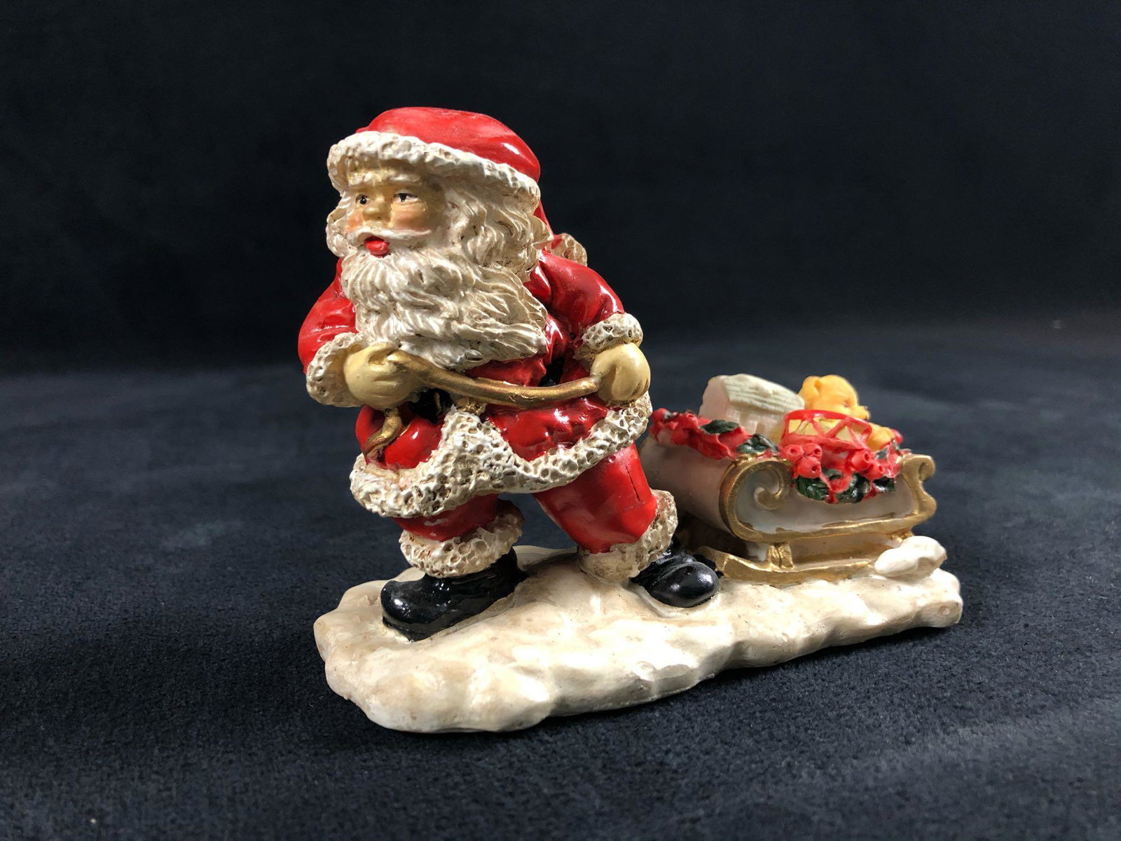 Santa Claus Figurine Pulling A Wagon Of Toys Holiday: Santa Claus Figurine Pulling A Wagon Of Toys Holiday Snow This Santa Claus is ready to be displayed in your home for the holidays. Appears to be made of clay with a hollow center. In great condition w