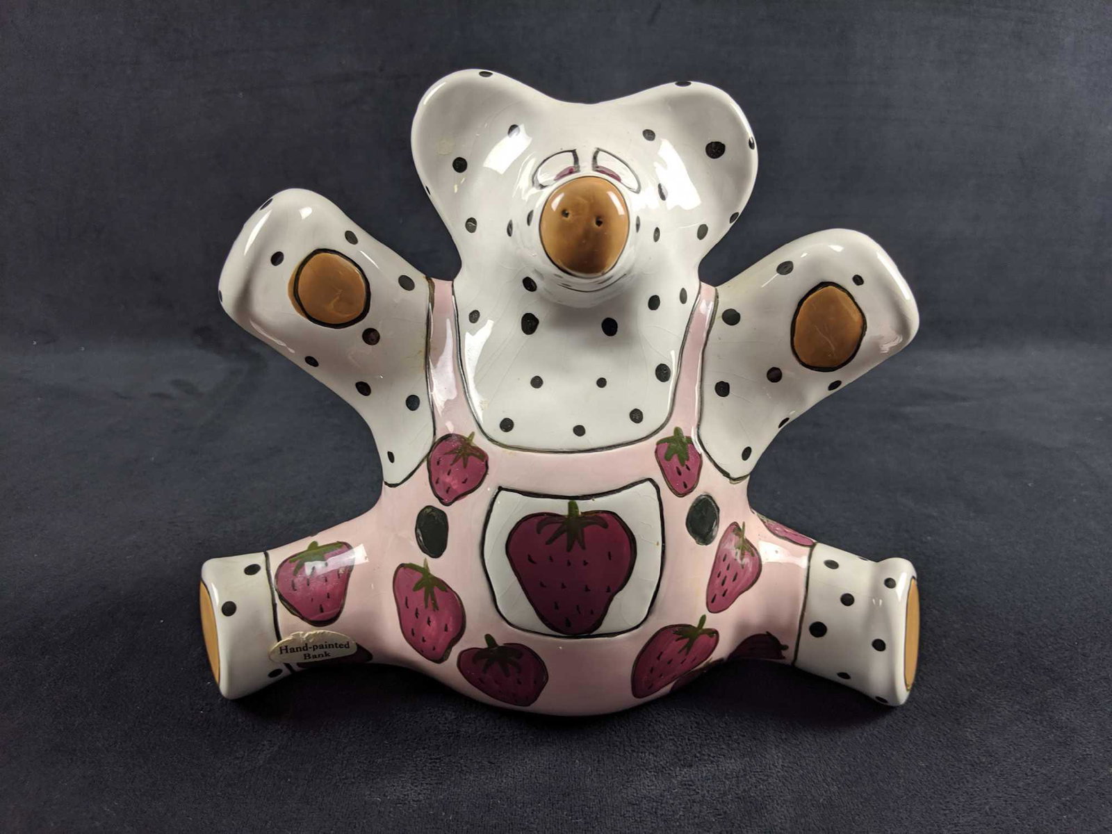 Vintage Hand Painted Ceramic Bear Piggy Bank By Ganz: Ceramic bear in overalls by Patti. Bear is approx 9" x 4" x 7". Bear is in good, vintage condition with light scuffs and sticky residue caused by product stickers. Has lightÂ crazing.