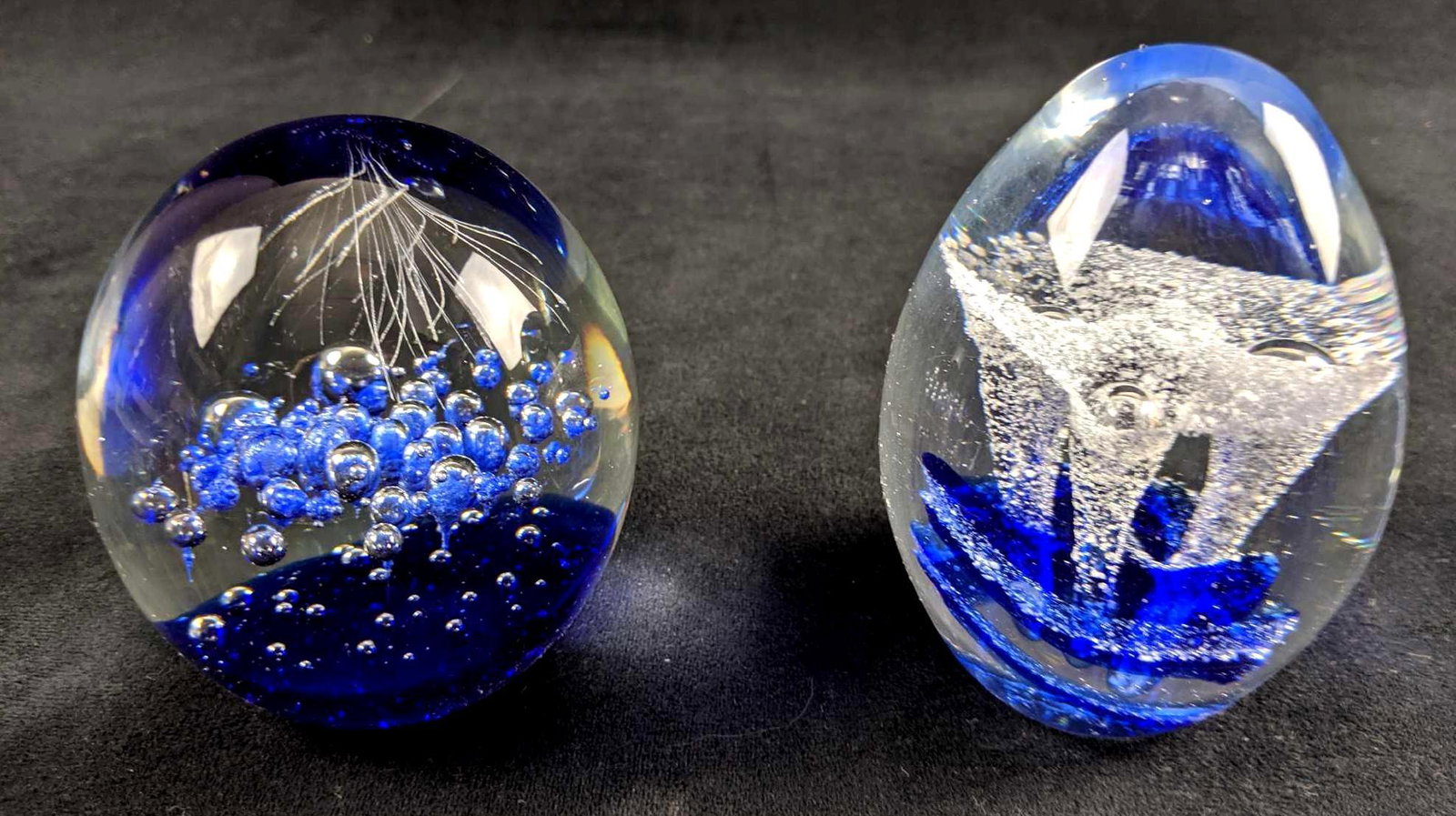 Set Of Two Glass Paperweights: This is for a set of two hand blown glass paperweights. Each one is one of a kind and shows an abstract floating design inside. Floating bubble design measures approx 3" x 4". Floating flower design m