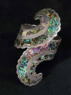 Sterling Color Mosaic Wrap A Round Cuff Bracelet: This wrap around cuff braceletÂ marked sterling depicts mosaic color reflective tile pieces. Measures 2 1/4"Â across, however is adjustable and 4 1/2" in length. In good used condition with some
