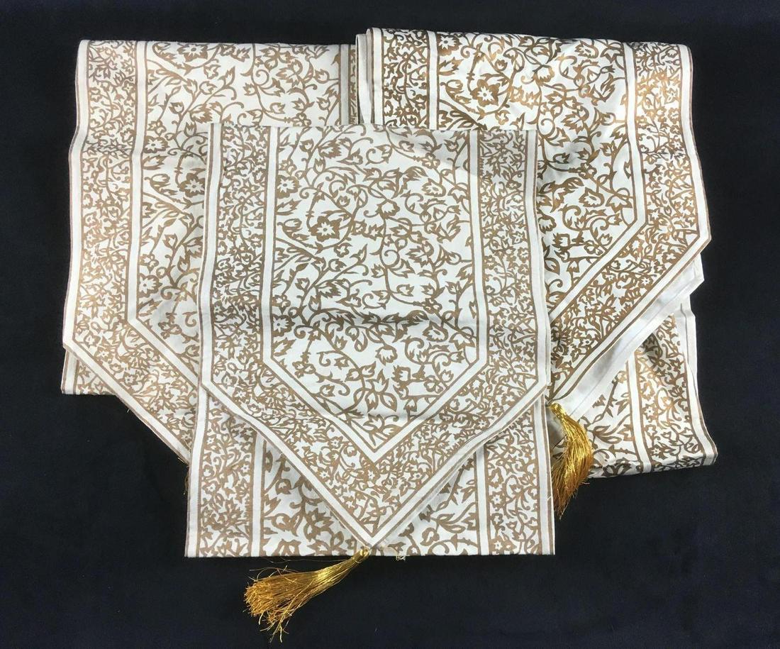 Indian Tasseled Table Runners: Indian Tasseled Table Runners. These table runners are in fair condition. Three of the six gold tassels need to be reattached and the runners are slightly dirty and need to be washed. The color of two