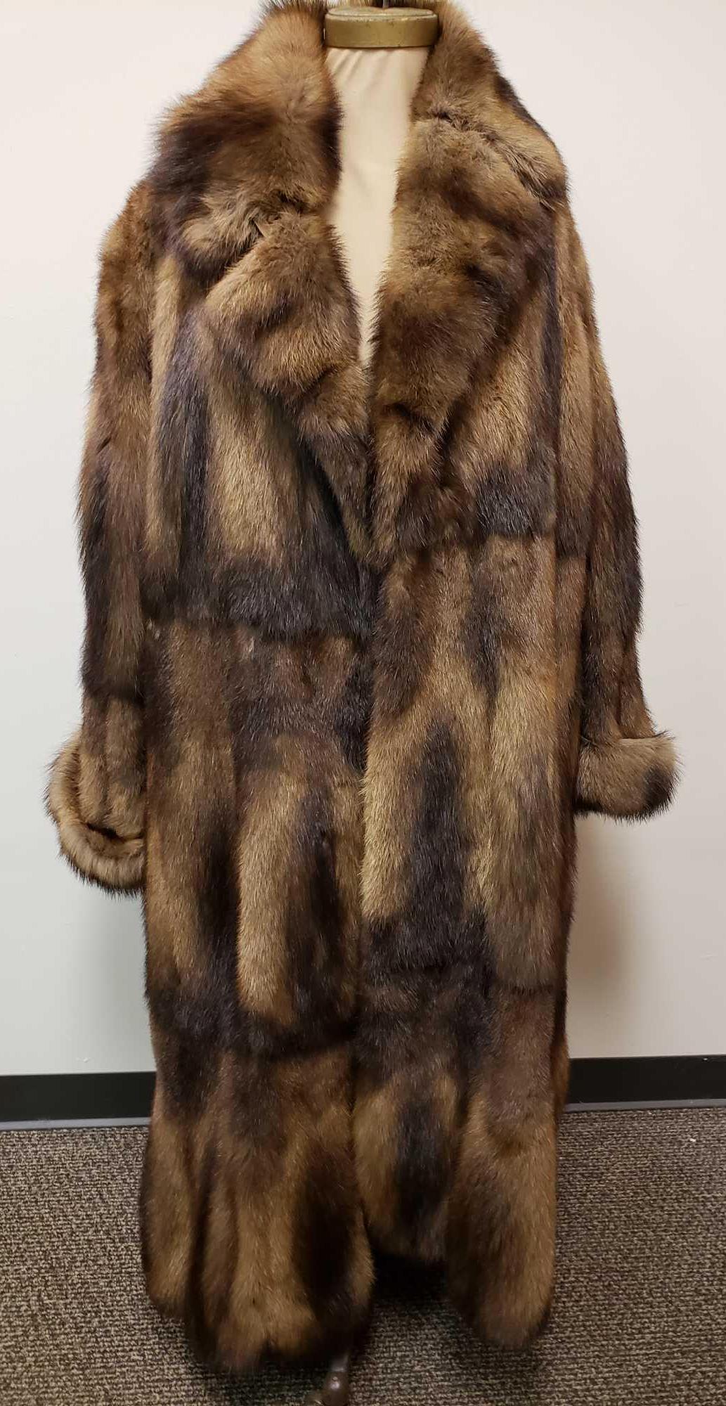 Full Length Fisher Fur Coat: Full Length Fisher Fur Coat This fur coat is in great used condition. The coat only shows minor signs of being worn, with no other known damage. The interior of the coat is brown with no labeling. Fur