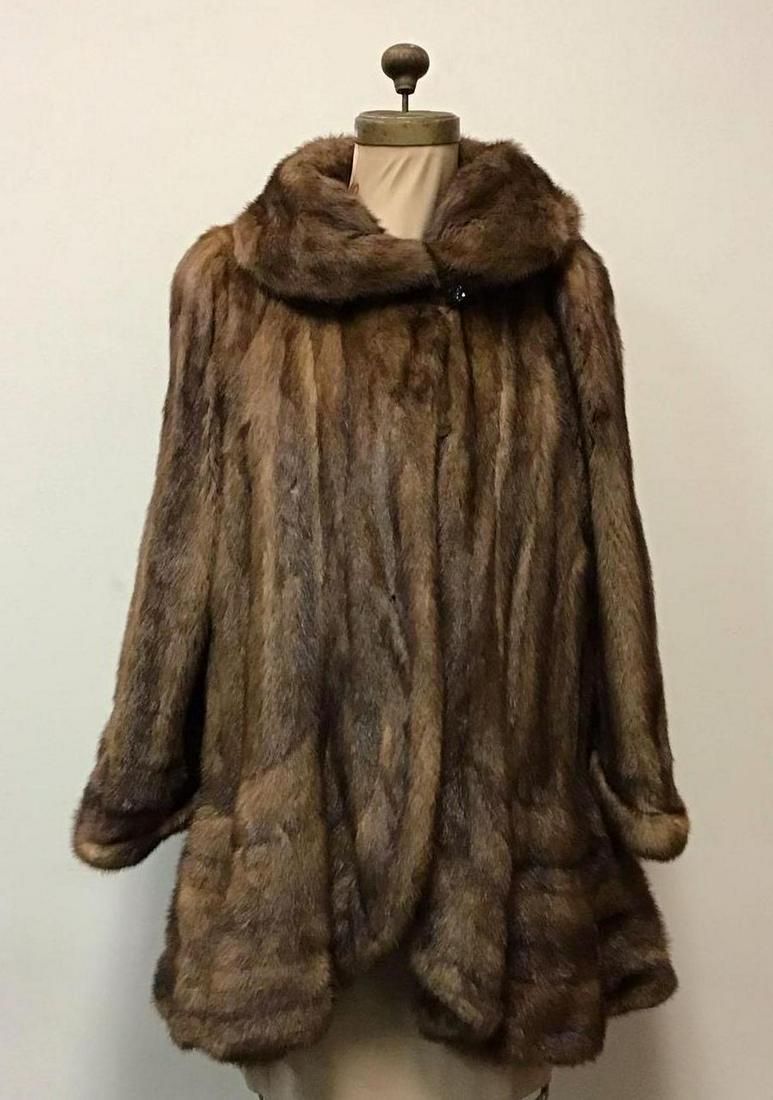 Lunaraine Mink Fur Button Coat: Lunaraine Mink Fur Button Coat. Made by an unknown manufacturer. This coat features cuffed wrists, brown patterned linen interior, one button closure, two hook and clips and two exterior pockets. It i