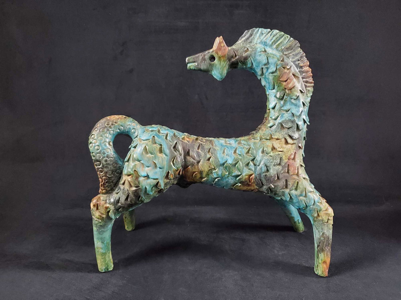 Vintage Horse Clay Sculpture: This vintage horse clay sculpture is at least 40 years old and depicts a horse looking black with blue, green and brown hues and heavy texture. This piece is unsigned and dated. In good condition with