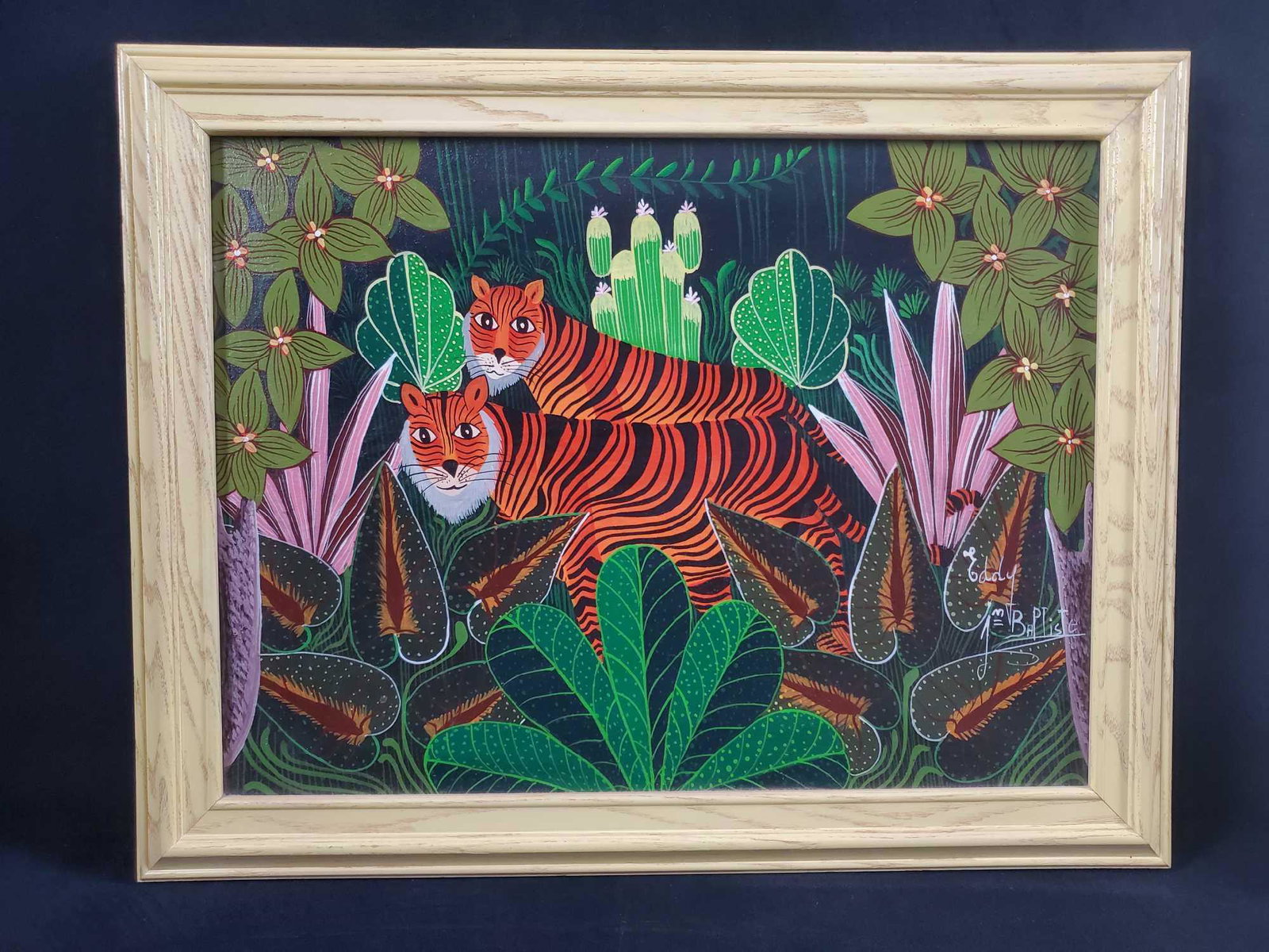 Tigers by Eddy Jean Baptiste Haitian Art: This art piece by Eddy Jean Baptiste depicts two tigers in a jungle. Original acrylic on canvas. In very good condition with no known damages. Framed in a complimentary light yellow. Measures approx 1