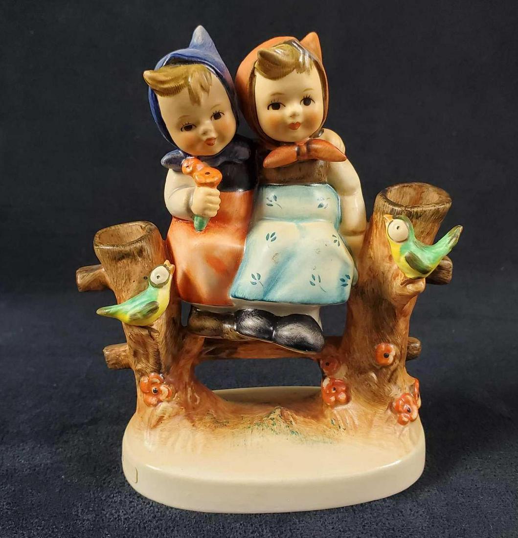 Hummel Goebel Figurine Coquettes HUM 179: TwoÂ Bavarian girls sit on an old fence as two little birds watch on. The figure is in good, vintage condition with only minor scuffs on blue dressed girl's knees. Figure is approx 5" x 2" x 5". Mad