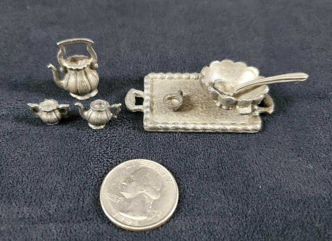 Dollhouse Pewter Miniature Tea Set: This vintage dollhouse pewter pieces consists of a serving tray, bowl and ladle, tea kettle, tea pot, creamer and one tea cup. The tray is marked Emson Taiwan. In very good condition with no known dam