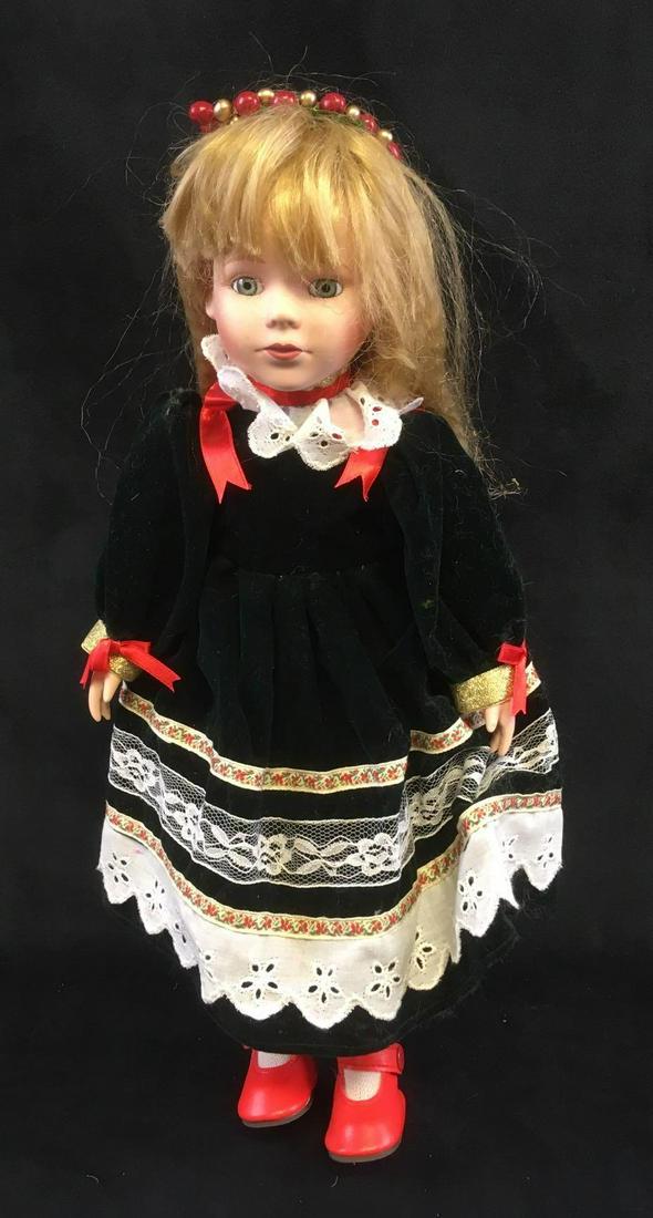 JC Penney Collectors Porcelain 1992 Doll: JC Penney Collectors Porcelain 1992 Doll. This doll is in good condition. Doll has no chips or cracks in porcelain. The doll is wearing a velvet dress and has long crimped blonde hair. Has a soft body