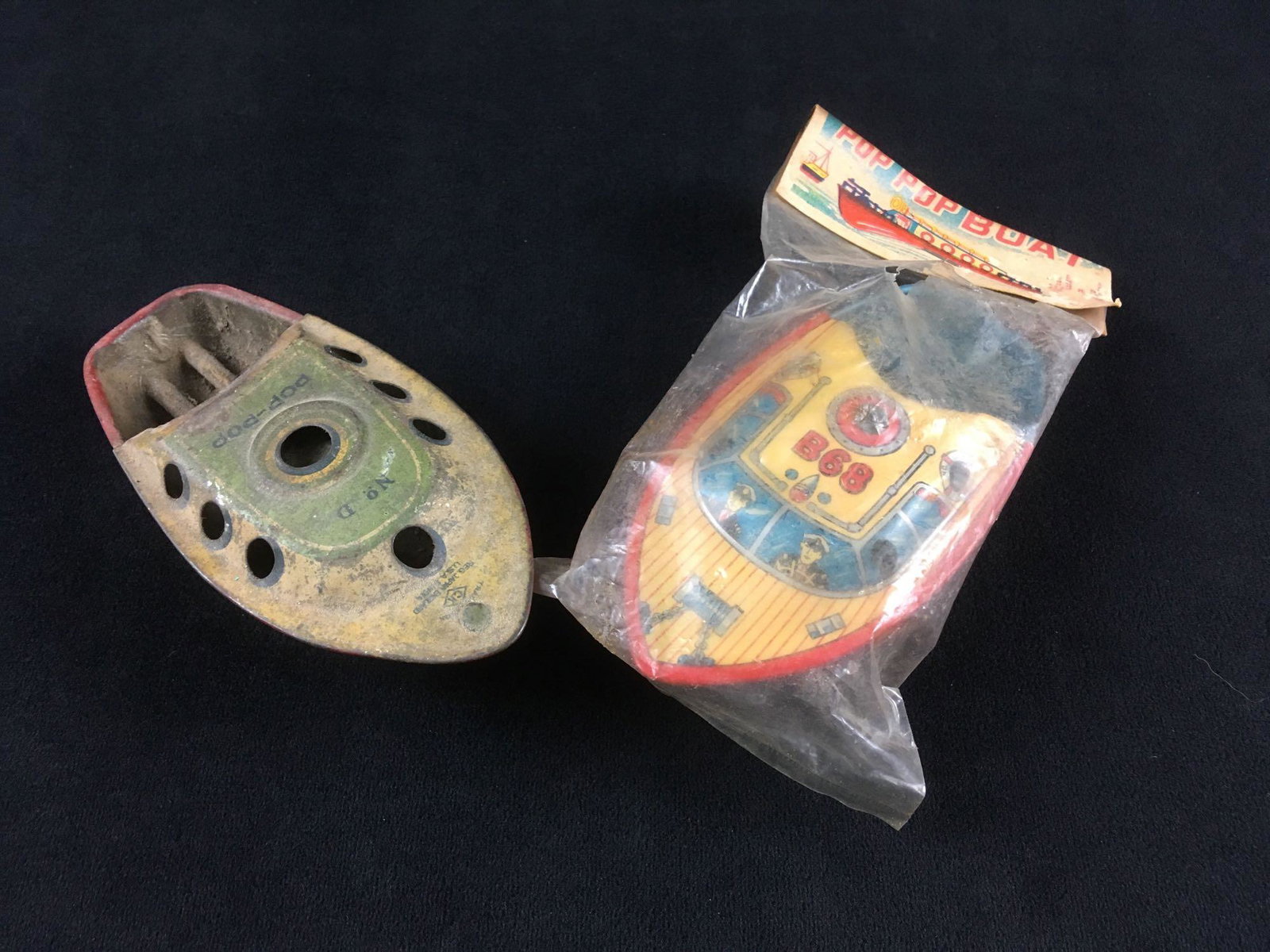 2 Vintage Tinplate Pop Pop Boat with One New in the: 2 Vintage Tinplate Pop Pop Boats, One New in the Original Packaging; 2 great little toy boats; 1) marked "Trade Mark CK" and No. D,it is well used, deck and interior shows some wear but pain