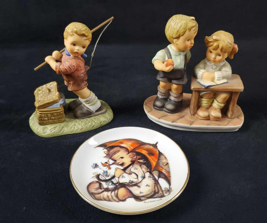 Hummel Goebel Figurine And Plate Lot Of Three: Hummel figurines are all in good, used condition only minor wearing on the bottom of the figurines. Lot includes: (1) Mini PorcelainÂ M. J. Hummel Plate. Umbrella Girl. Date Unknown. Is approx 4" ac