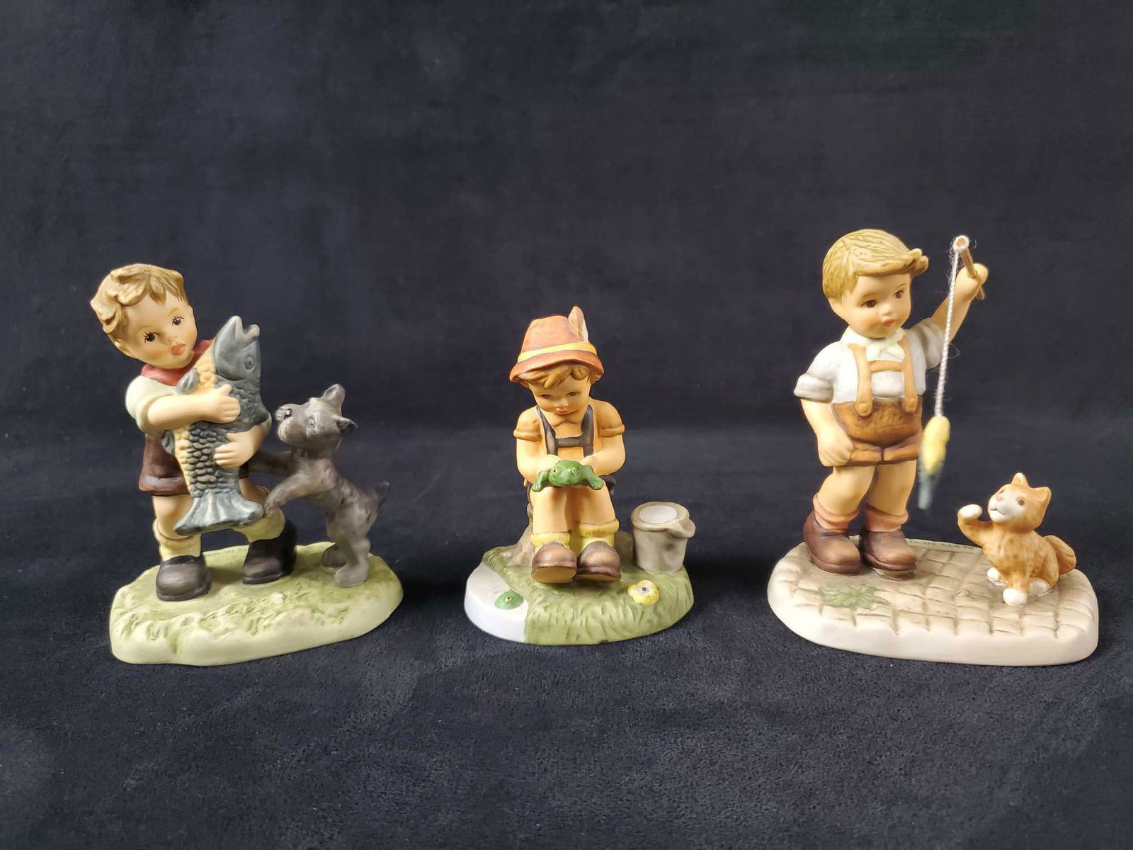 Berta Hummel Goebel Figurine Lot Of Three: Hummel figurines are all in good, used condition with no known damage. (1) Slippery Business 2001. BH 148. Figurine is approx 3" x 2" x 4".Â (1) Prize Catch 2005. BH 300. Figurine is approx 4" x 2