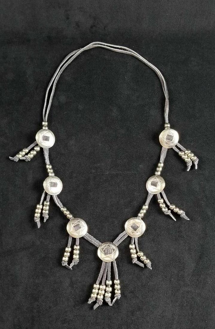 Handmade Western Leather Double Corded Necklace with: Handmade Western Leather Double Corded Necklace with Metal Stars and Tassels trimmed with metal beads. The necklace is in good used condition with some pin head size spots of rusting on metal plate. T