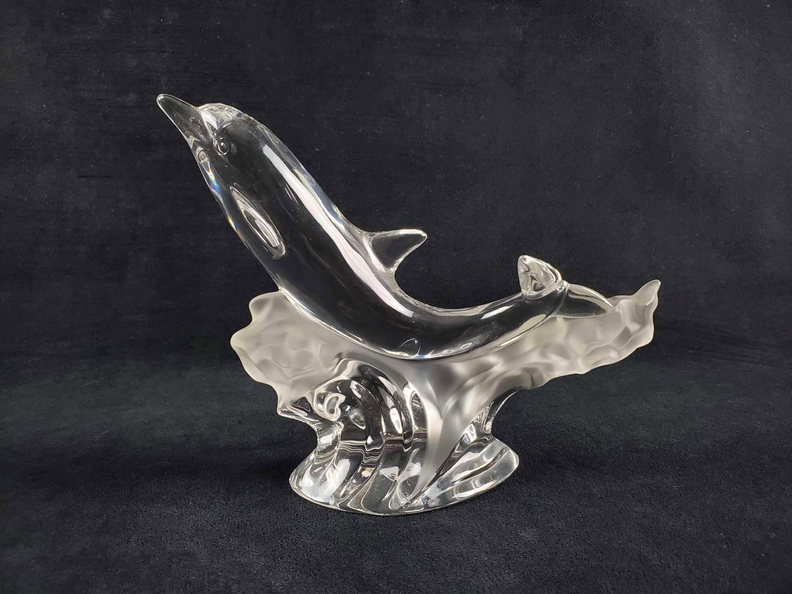 Lennox 1995 Glorious Dolphin Crystal: This glass crystal is of a dolphin jumping water, The "waves" have a frosted element. Lenox marking underneath. This piece is in very good condition with no known damages. Measures approx 7 1/2" x 2 1