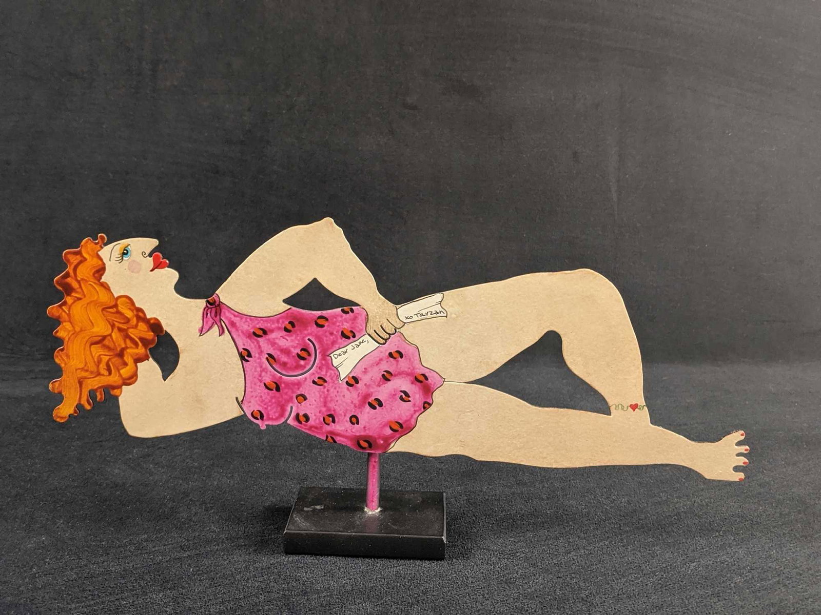 Judy Bomberger Die Cut Folk Art Jane From Tarzan: Hand-painted metal art of Jane Porter with a letter from Tarzan, her mate. Hand-signed on the back by the artist. Is approx 13" x 2 1/2" x 6". Metal art is in good, used condition with only minor wear