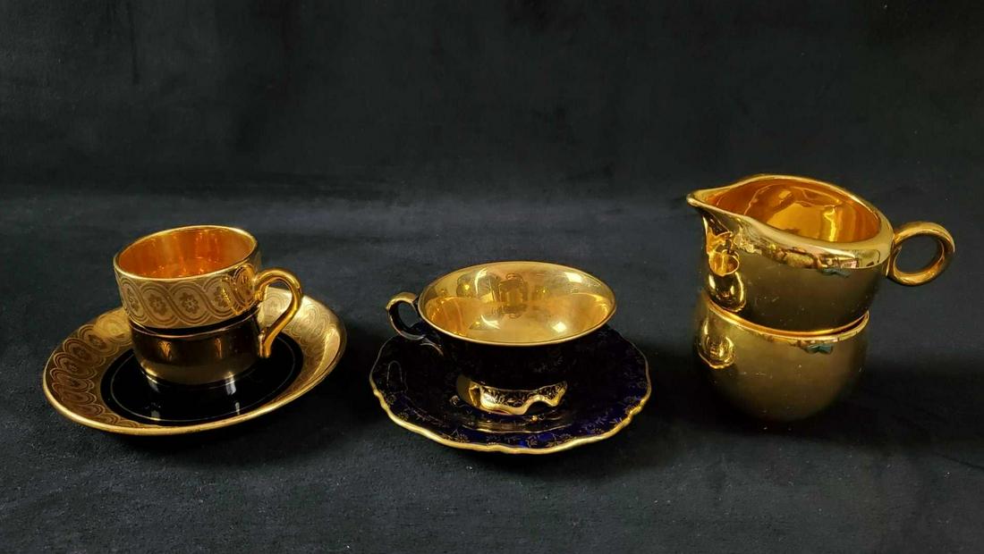 Six Vintage Gold Porcelain Tea Sake Saucer Creamer: This very shiny lot includes: (1) Warranted 22 Karat Gold Sake Cup. Is approx 2 1/2" x 2 1/2". Maker unknown. (1)Â Warranted 22 Karat Gold Creamer. Is approx 4" x 3" x 2". Maker unknown. (1) Gibson 