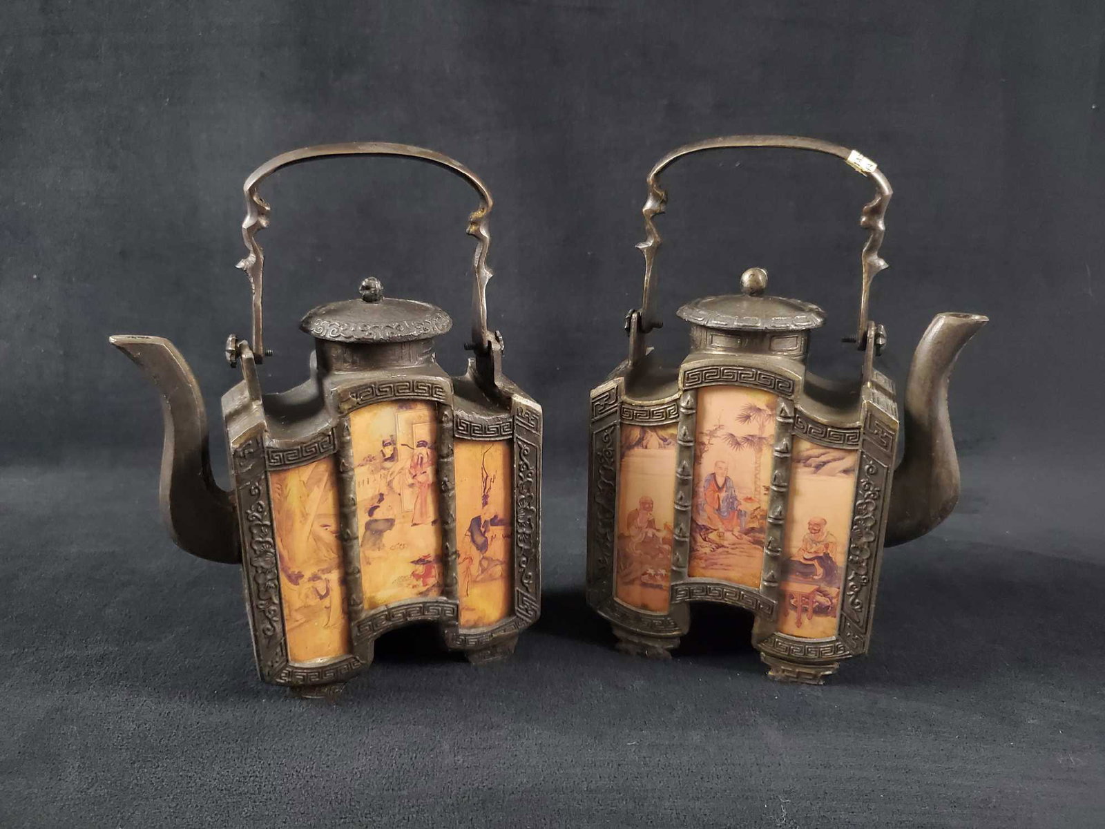 Rare Chinese Pewter Teapots Lot Of Two: Two decorative pewter and glass panel teapot from the Museum Company. Reproductions from the Ming and Qing Dynasty. Not intended for use with tea - only for decoration. Teapot are in good, used condit