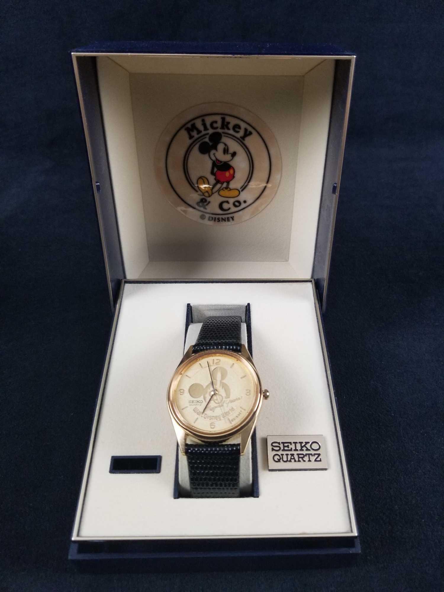 Walt Disney World Magical Years Watch by Seiko Quartz: This Walt Disney Magical Years Watch by Seiko Quartz and Mickey & Co depicts a gold tone embossed Mickey ear silhouette with Cinderella's Castle with a leather textured black band. This watch features
