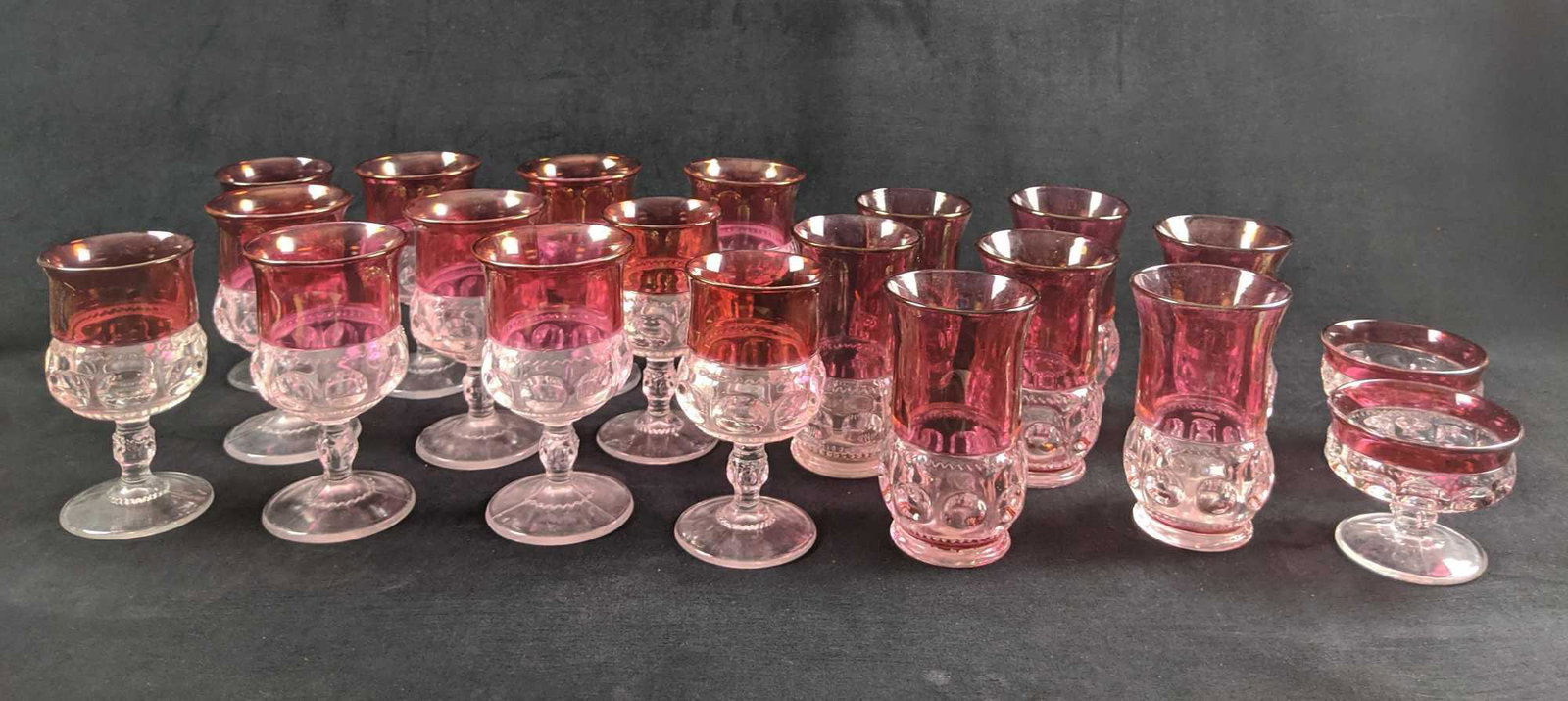 Vintage Ruby Red Tiffin Glass Lot Of Twenty 1960s: This lot includes: (7) Ruby Red Vintage Tiffin-Franciscan Kings Crown Drinking Glasses. These are approx 4" x 4" x 6". (11) Ruby Red Vintage Tiffin-Franciscan Kings Crown Goblets. These are approx 4"