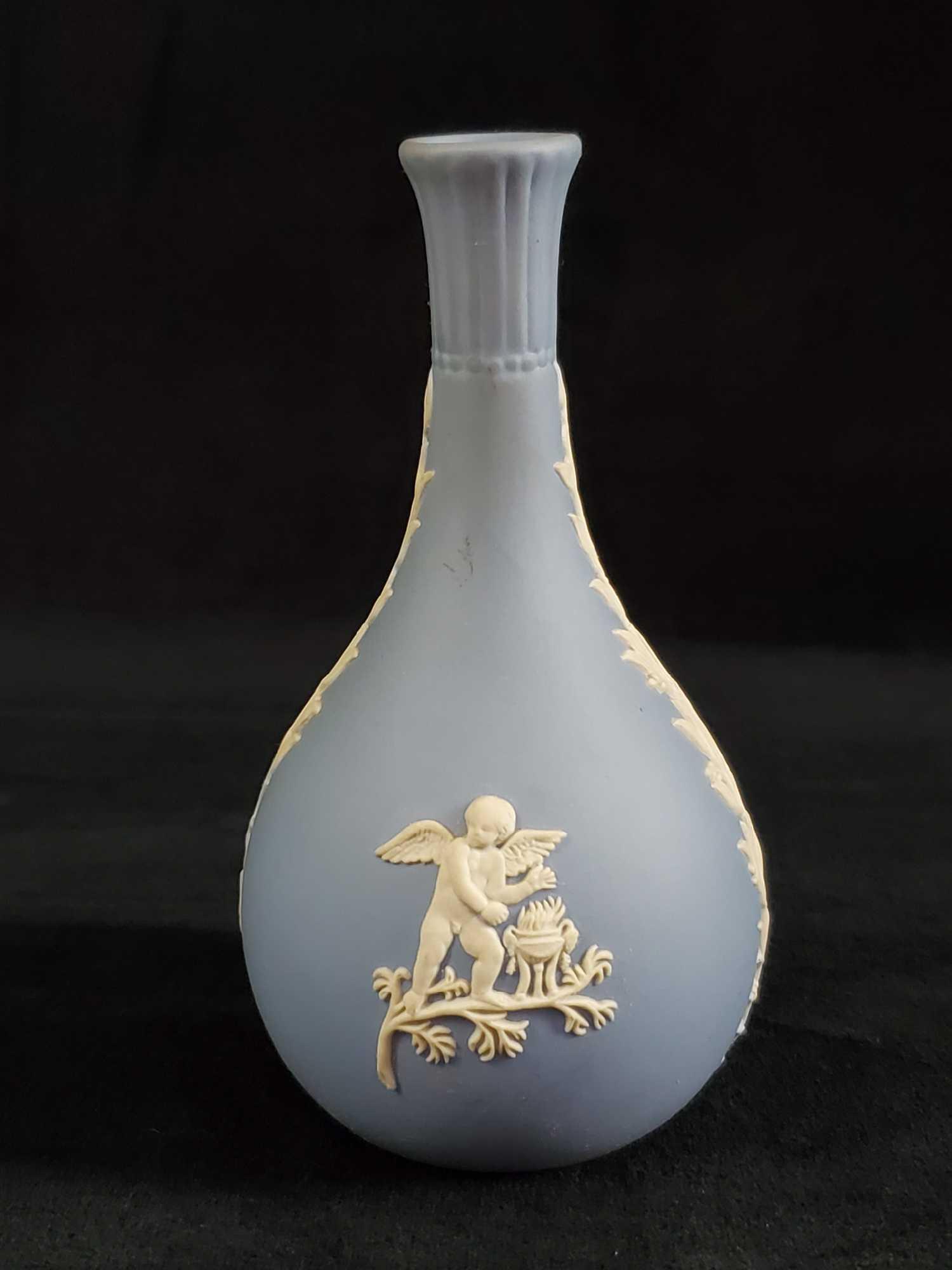 Vintage Wedgewood Cream On Blue Vase Fine China B: Vintage Wedgwood Light Blue Jasperware Short Bud Vase. Has small textured images of characters from Greek mythology and wheatÂ patterns on sides. Vase is in good, vintage condition with only a few v