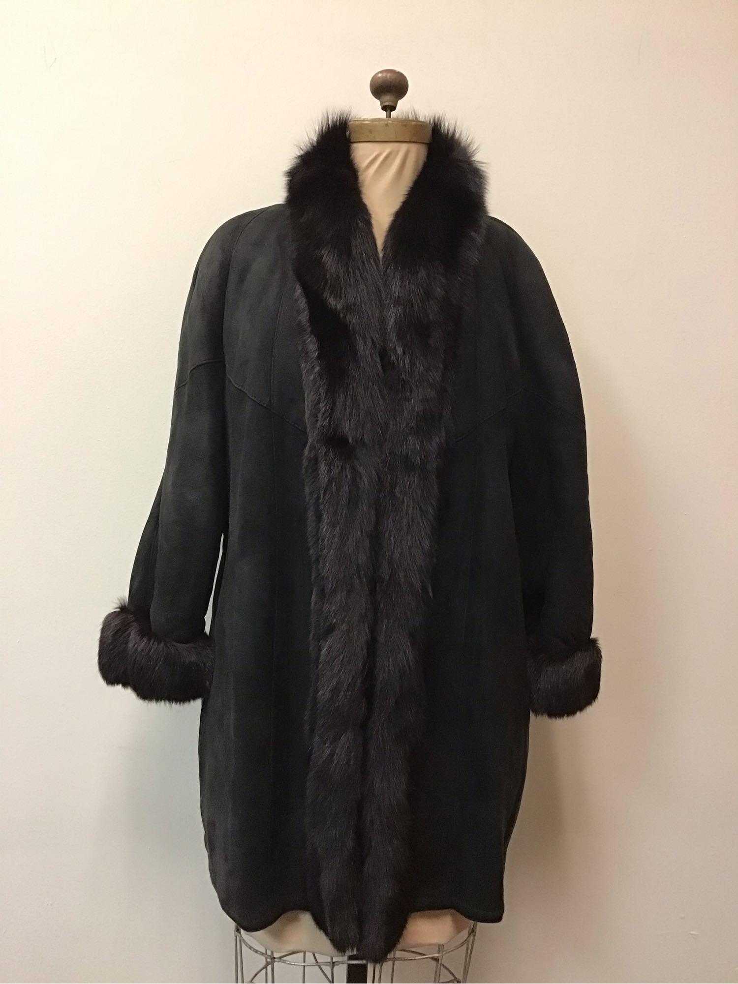 Black Shearling with Fox Suede Fur Coat Jacket: Black Shearling with Fox Suede Fur Coat Jacket. Made by an unknown manufacturer. This coat features cuffed wrists, two exterior pockets, two button closures, a "Abioxos" tag on the left interior. This