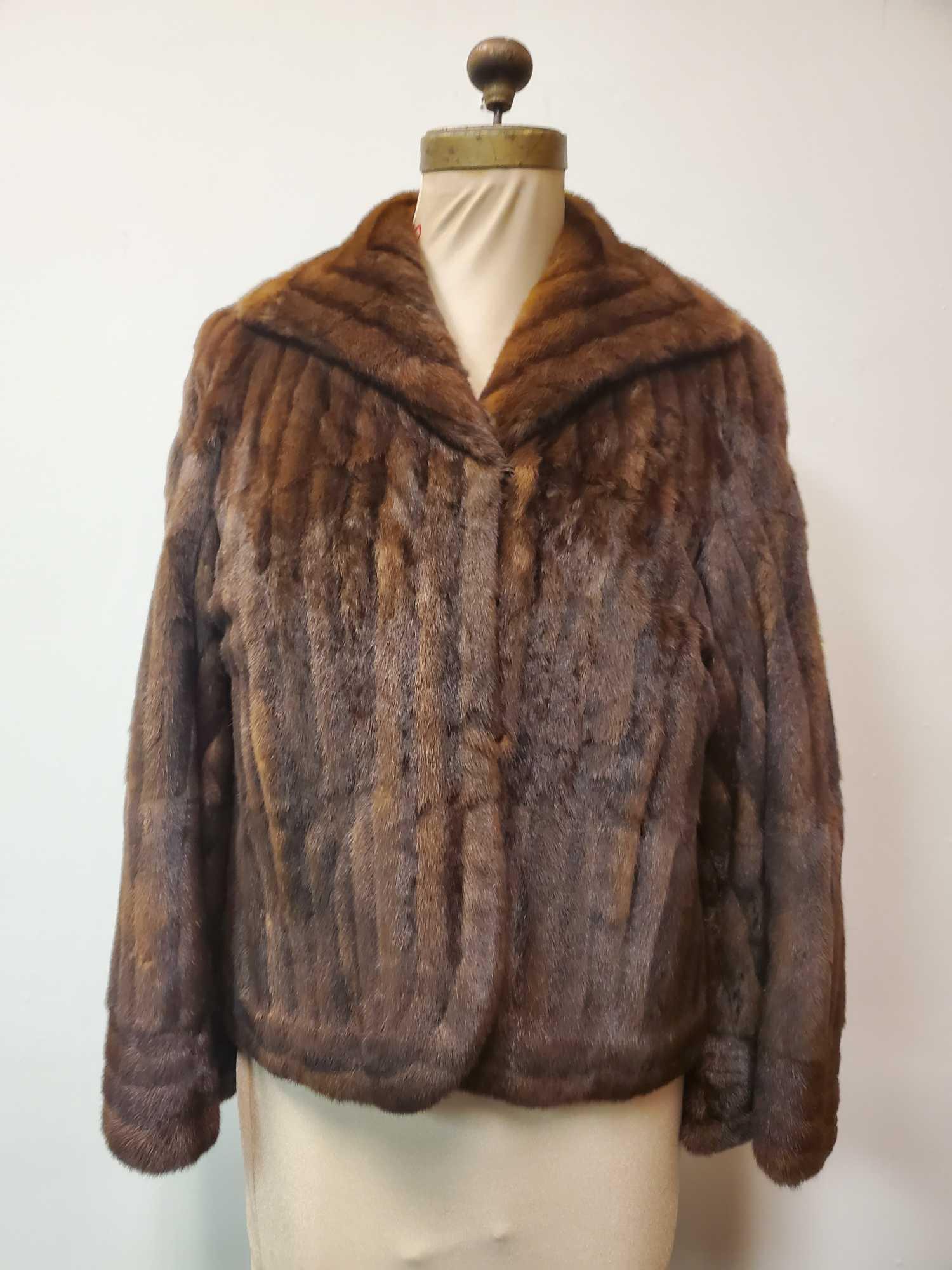 Vintage Brown Mink Fur Coat: This vintage brown mink fur coat is made by an unknown manufacturer. It has a midcentury modern look. It features 2 hooks for closure, 2 outside pockets, dark brown interior and "A.J Nelson" embrioder