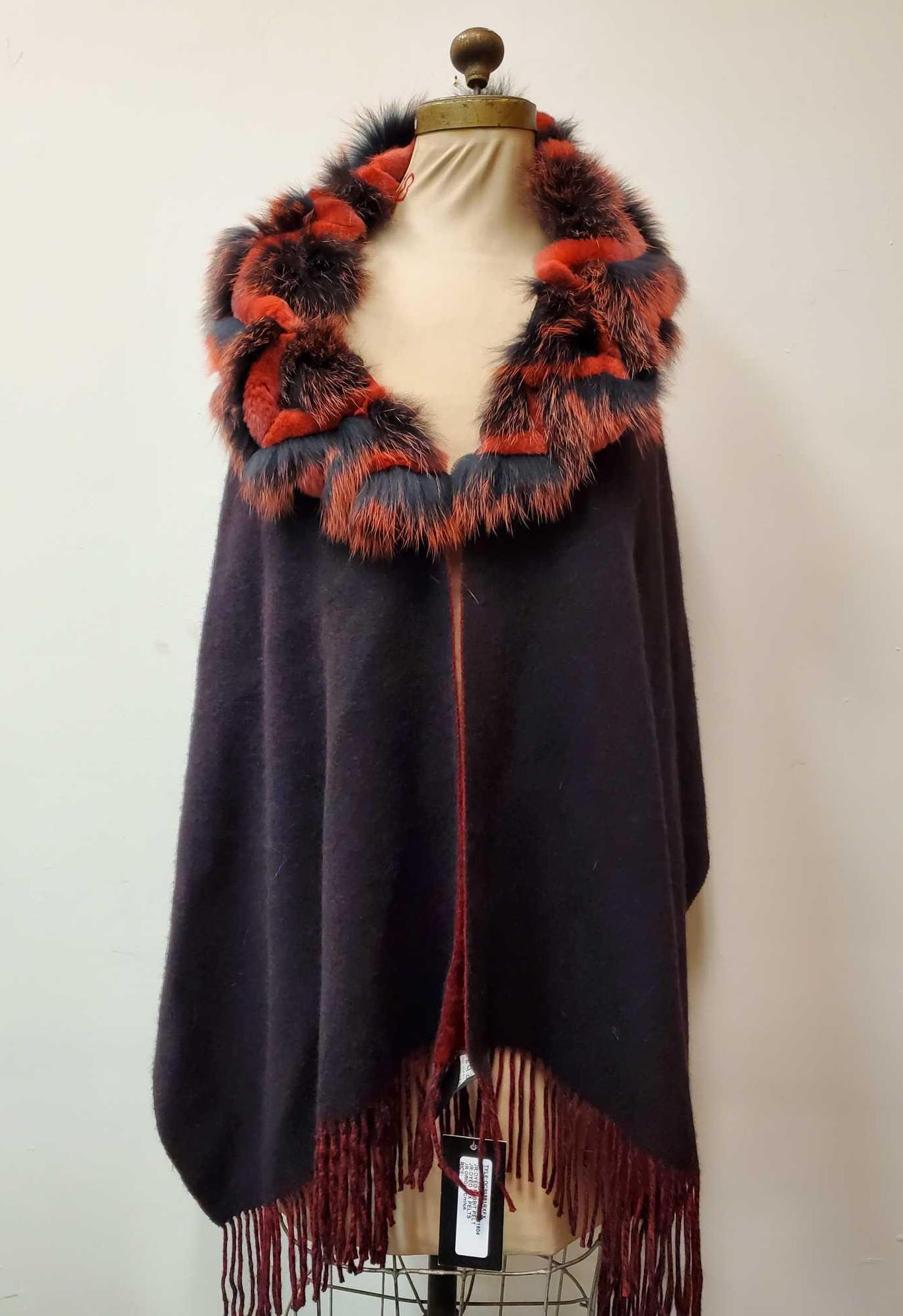 Reversible Cashmere and Fox Shawl by Gaspari: This unique reversible shawl by Gaspari: Maryse Roye Designer is made from 70% wool and 30% Cashmere. The trim is is black and red dyed fox in a chevron pattern and the bottom of the shawl has a fring