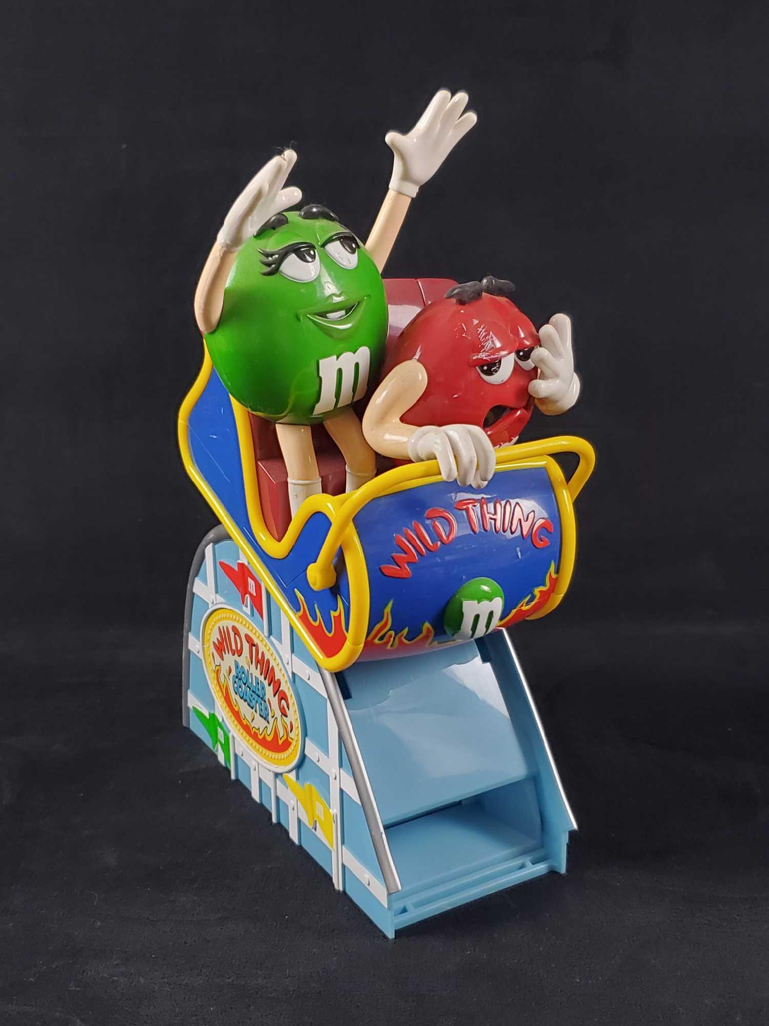 M&M Wild Thing Roller Coaster Candy Dispenser Vintage: Vintage M&M Wild Thing Roller Coaster Candy Dispenser. This lot features Ms. Green and Alive Red on a Roller Coaster ride! Manufactured by M&M brand in 2002. This plastic toy is in good used condition