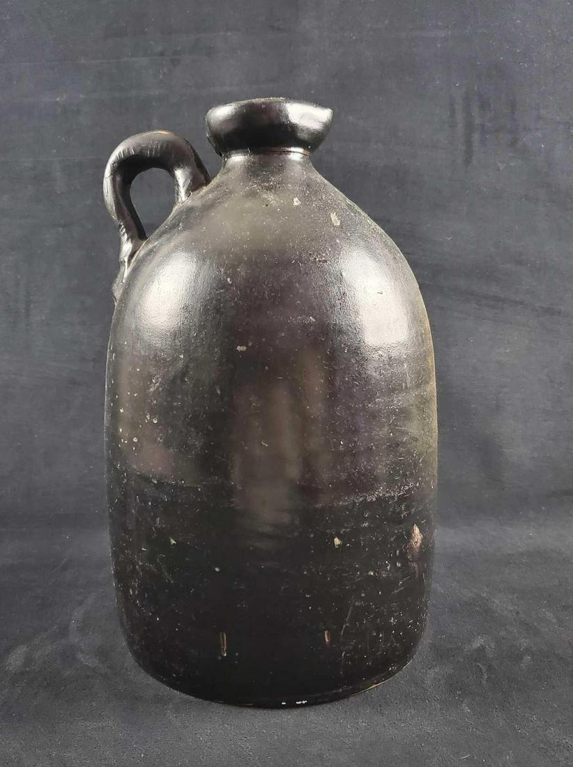 Antique William Warner Stoneware Black Jug 1800s: Rare W.M. E. Warner, West Troy Stoneware two-gallon jug. Large black jug from the 1800s. Marked with the company name and a large two for as many gallons it could hold. Jug is approx 9" x 9" x 14 1/2"