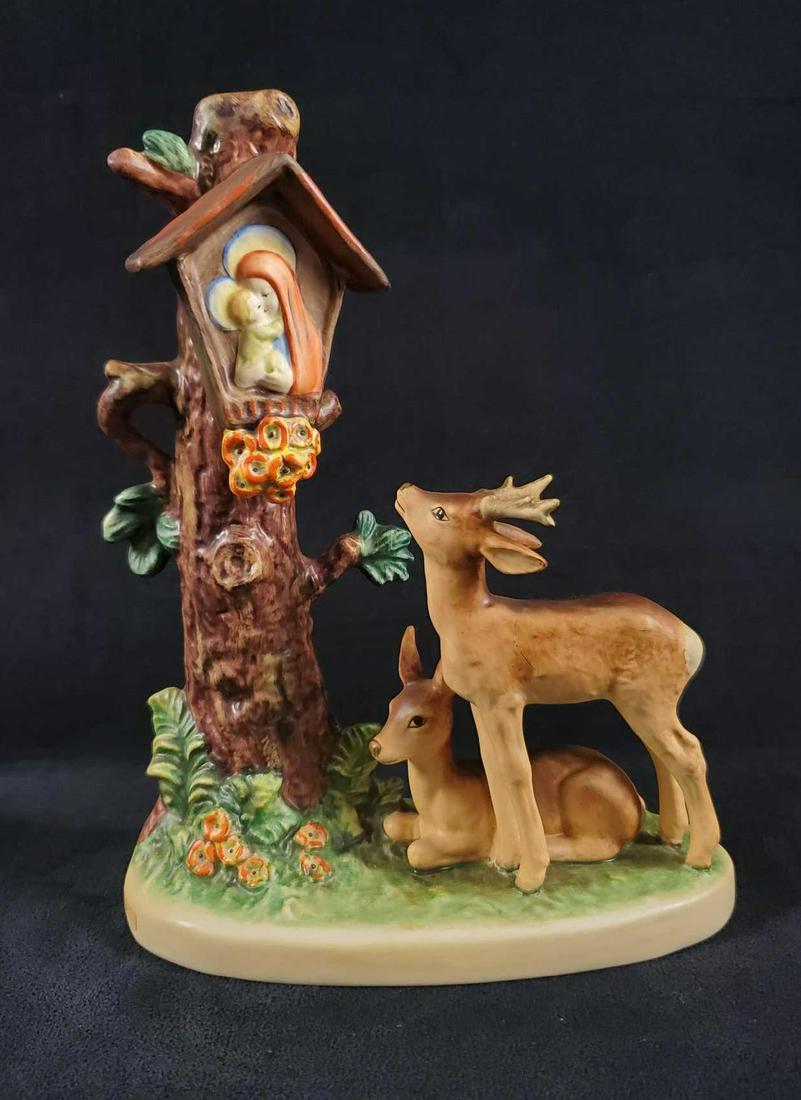 Hummel Goebel Forest Shrine Deer Figurine: This figurine features two deer in the middle of the woods next to a make-shift shrine.By Goebel/MI Hummel. Figure is made from hand paintedÂ porus earthenware. Made in the 1990's. Figure is approx