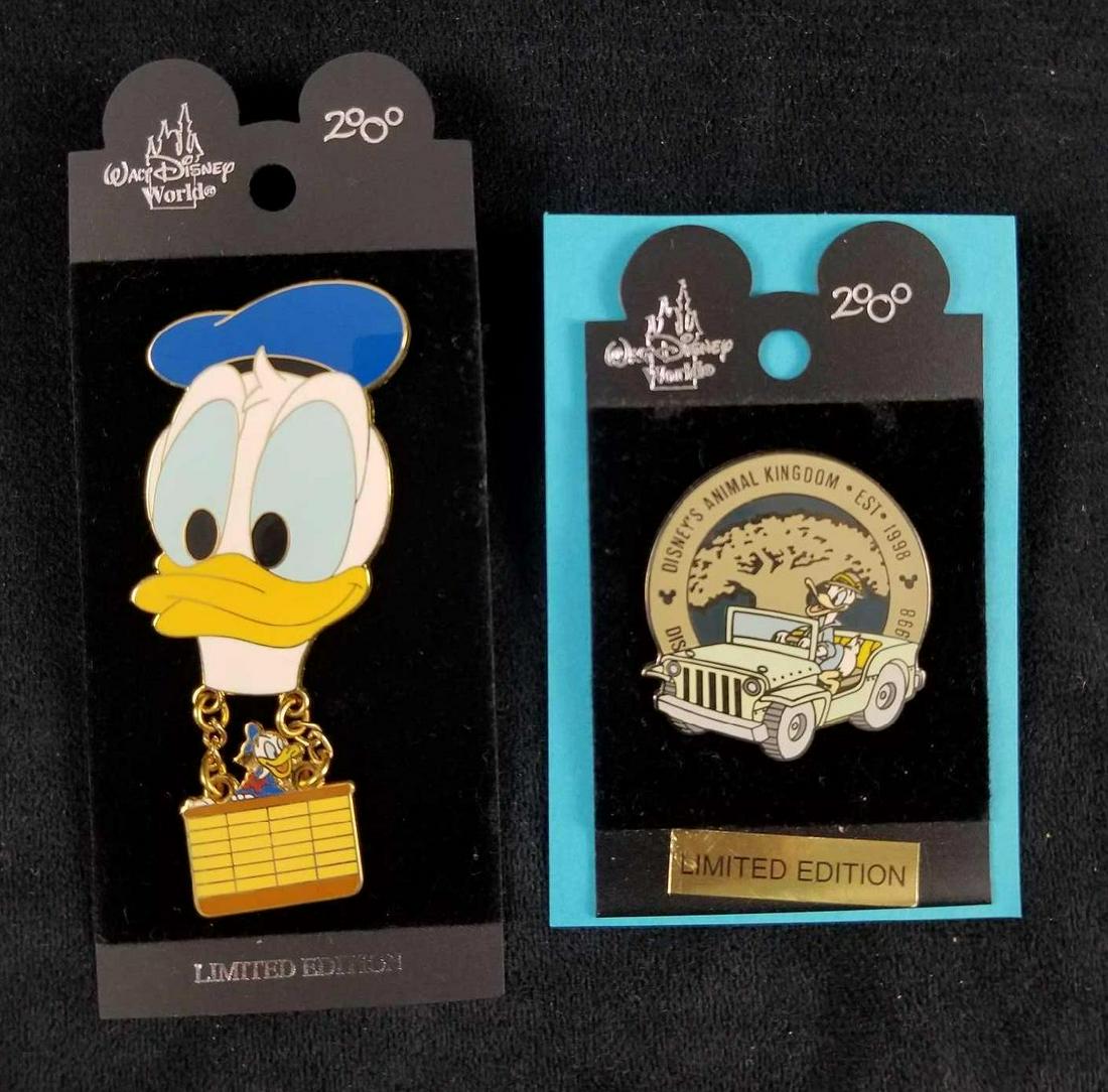 Lot of 2 Limited Edition Donald Duck Enamel Pins With: 1)Walt Disney World Millennium 2000 - Animal Kingdom Logo Donald Est. 1998 Pin with original backing. This item is in good condition with no signs of damage. Measures 1.5" in diameter. 1) 2000 Limited
