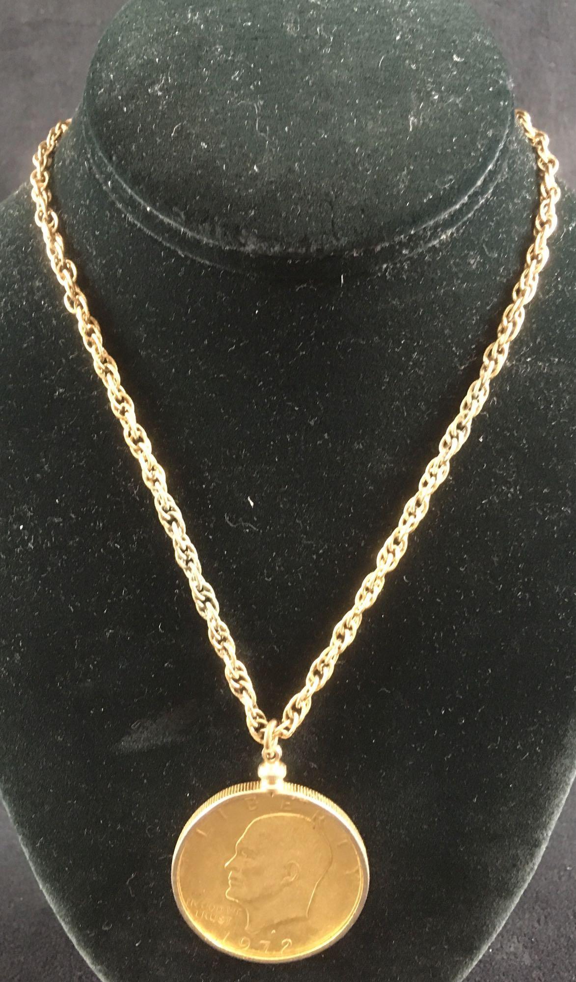 Eisenhower Gold Toned necklace: A vintage necklace fashioned from a 1972 Eisenhower dollar in a gold tone. 16" chain has some discoloration, coin itself is in good condition. 