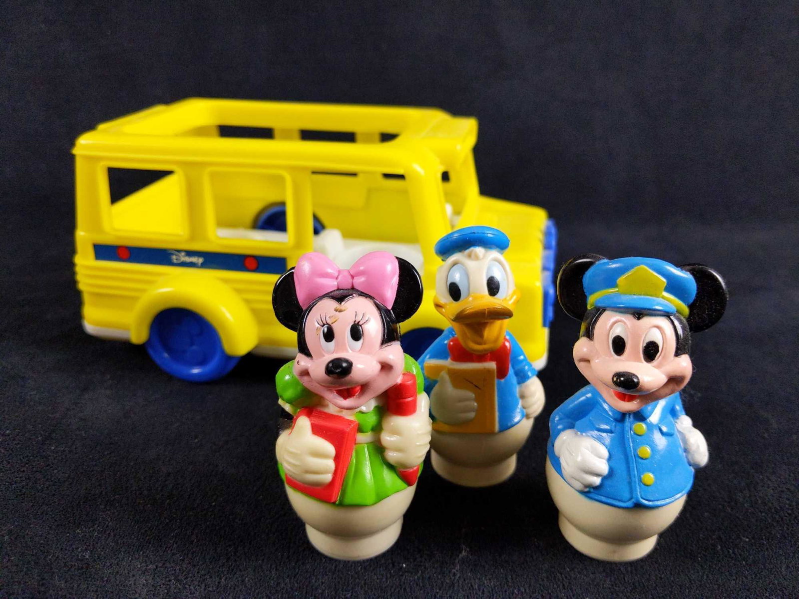 Vintage Arco Disney Mickey and Friends Yellow School: Vintage round people school bus playset by ARCO. This set includes the yellow school bus with blue details , Mickey,Minnie and Donald. All the characters fit nicely in the 3 corresponding spots inside