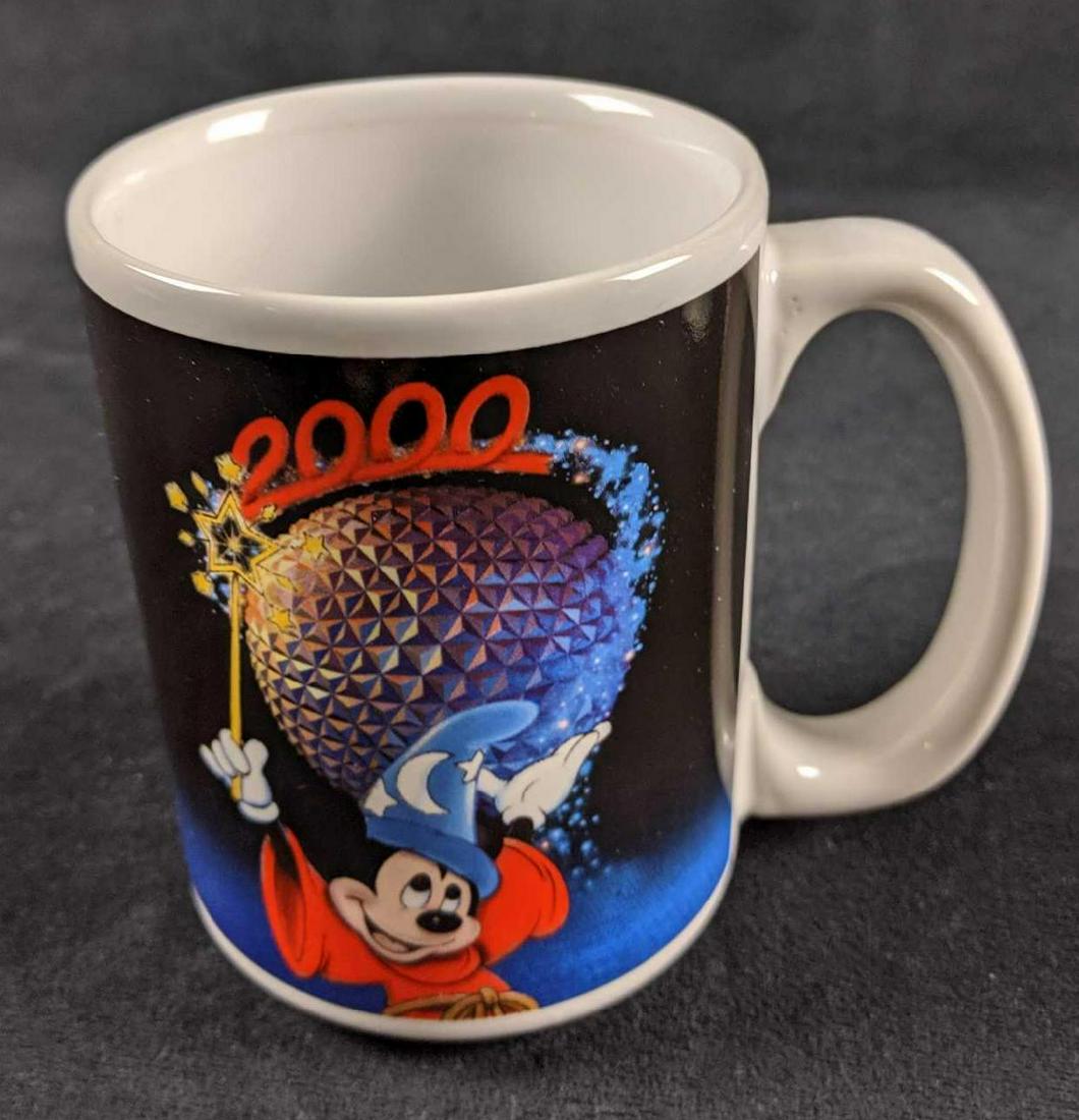 Disney Celebrate The Future Hand In Hand Epcot Mug: This is one "Celebrate The Future" Epcot ceramic mug. Colorful mug shows Epcot's centerpiece attraction, "Spaceship Earth" along with Sorcerer Mickey. This mug is in good, used condition with no notic