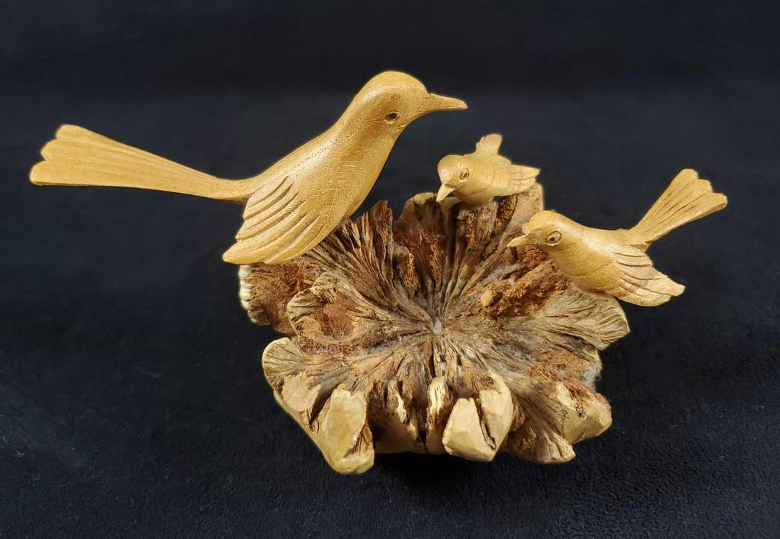 Unique Hand Carved Birds Nest Sculpture: This lovely hand carved wooden nest shows a larger, older bird showing off their new nest to smaller, younger birds who do not seem to be impressed. Sculpture is in good, vintage condition with only o
