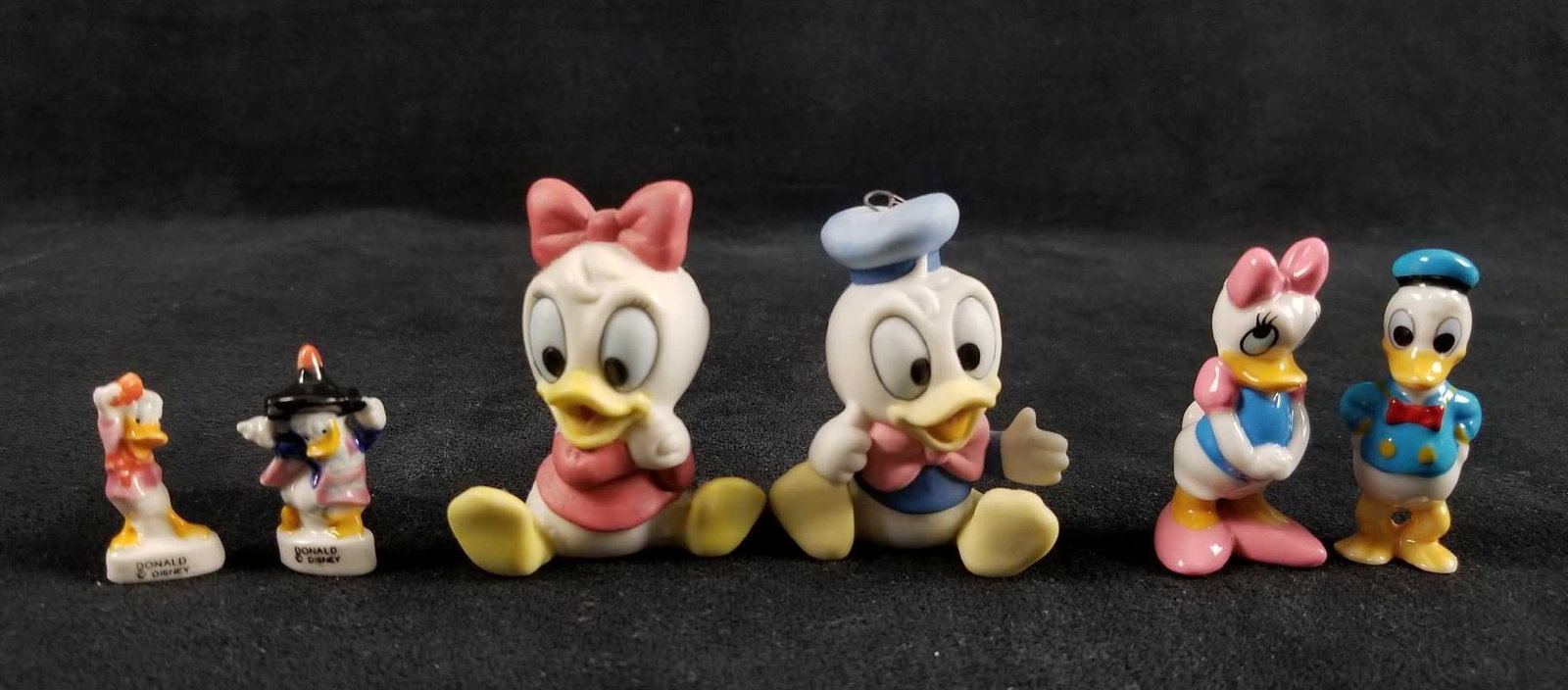 Lot of 6 Donald And Daisy Figurines: This lot of 6 Donald and Daisy figurines features: Â 2 Baby Donald and Daisy Porcelain figurines made in Sri Lanka. These figurines are hand painted beautifully and are in very good used condition w