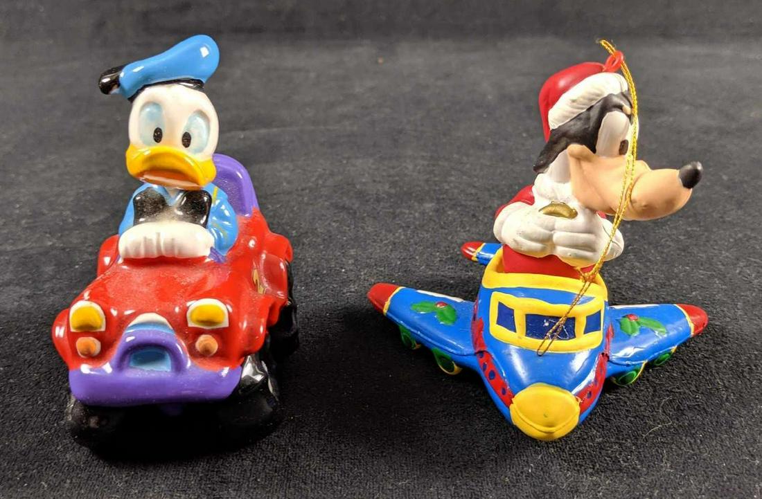 Disney Donald Duck Goofy Toy And Ornament: Lot comes with one Santa Goofy resin Christmas ornament and one glass Donald Duck with go-cart. Donald is approx 3" x 2" x 2". Goofy is approx 4" x 4" x 4". Both are in good, used condition with Donal