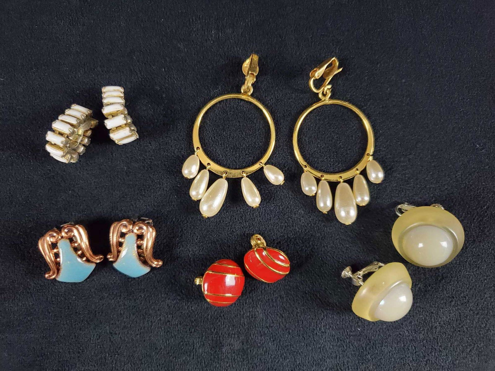 5 Vintage Clip on Earrings: This 5 piece lot of vintage clip on/ no pierced earrings consists of: (1) A pair of red with gold tone dome shape earrings marked Monet. In good condition with no known damages. They measures approx 2